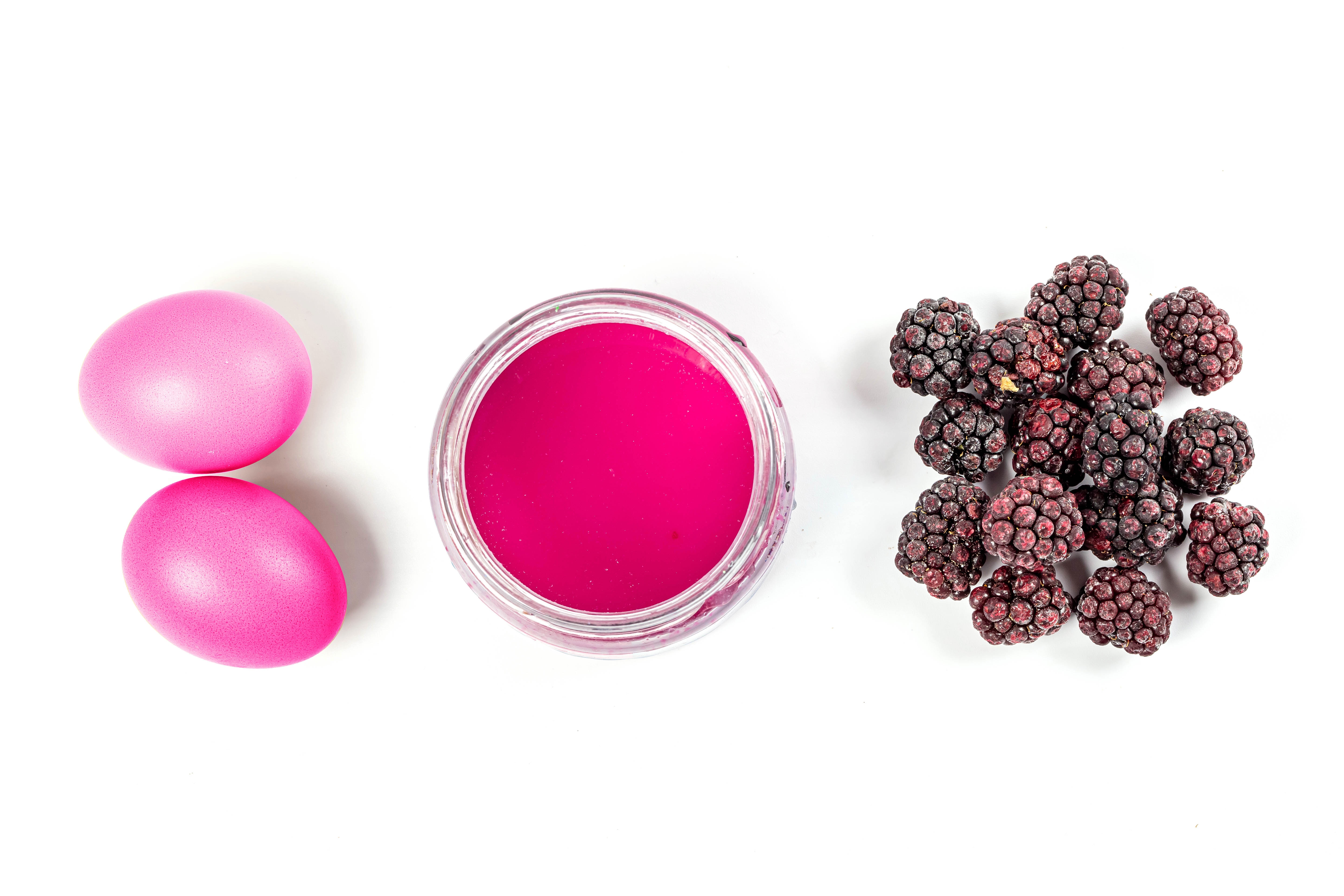 Pink eggs, pink paint, and blackberries on white background HD Wallpaper