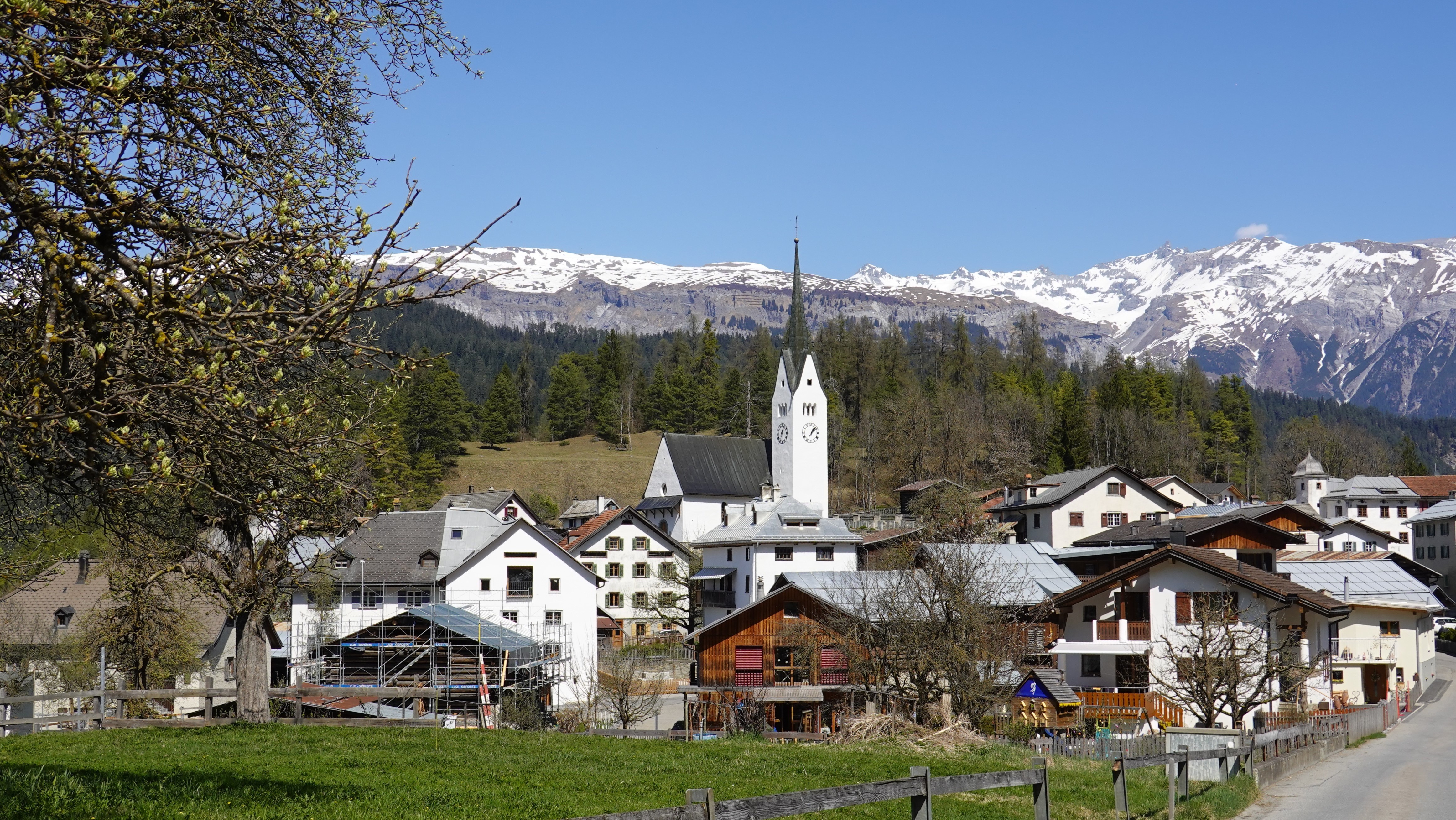 Village with Church and Snow-Capped Mountains in Switzerland HD Wallpaper