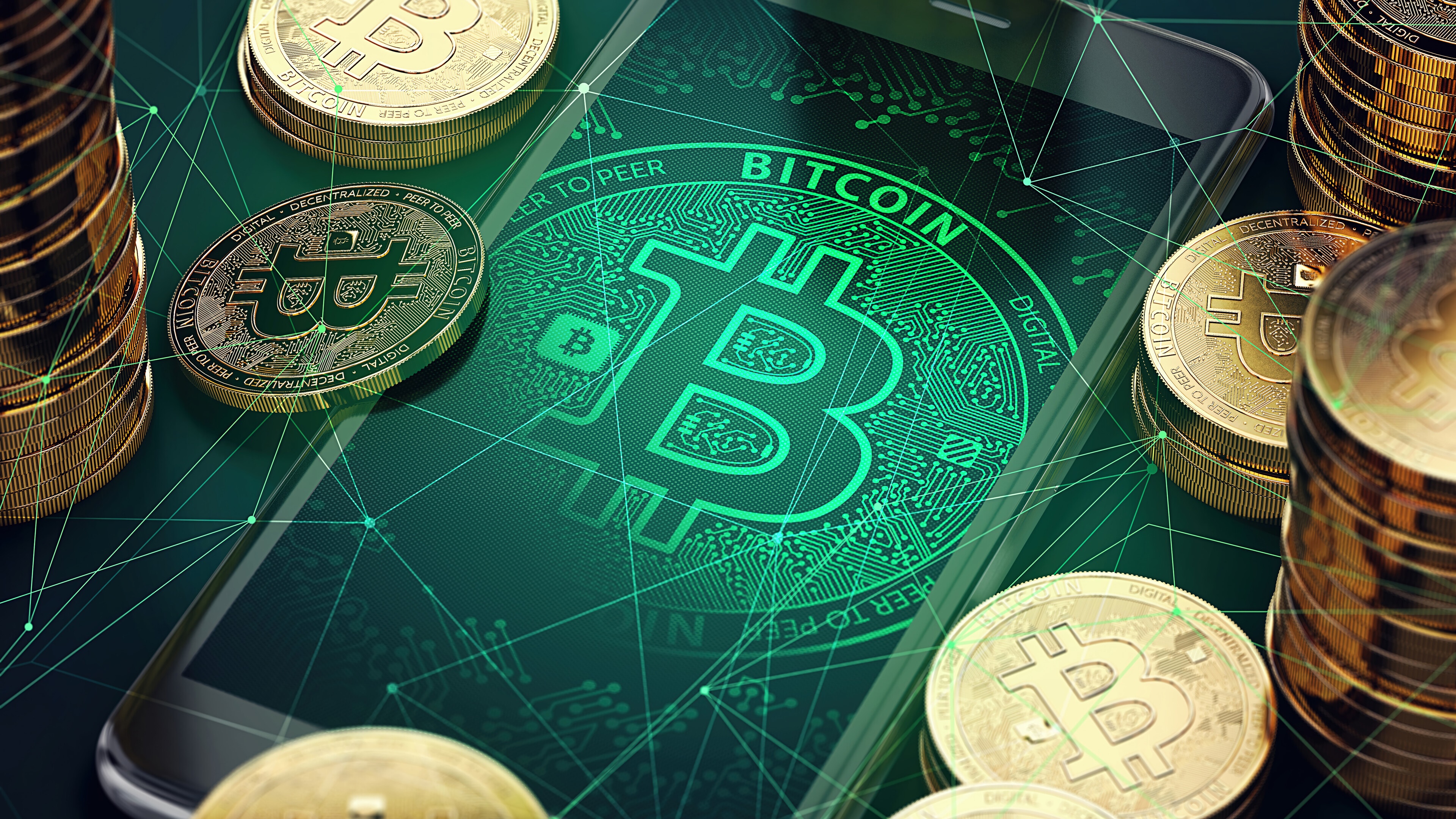 Bitcoin cryptocurrency on a smartphone screen with stacks of coins HD Wallpaper