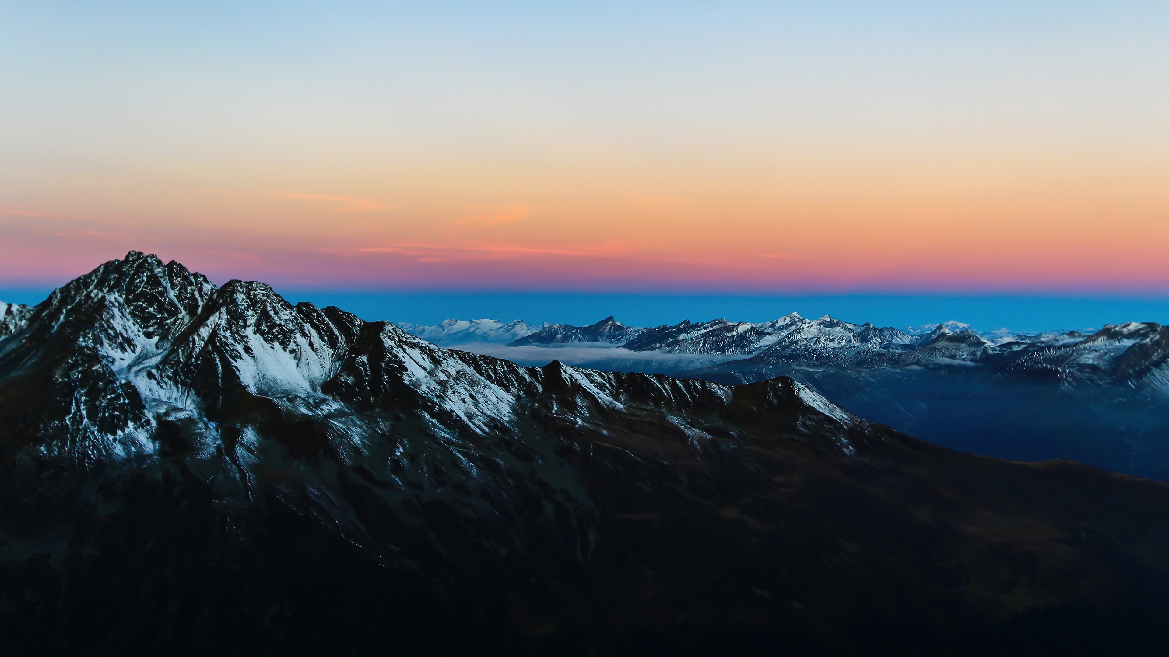 Snowy mountains at sunrise 4K HD Wallpaper