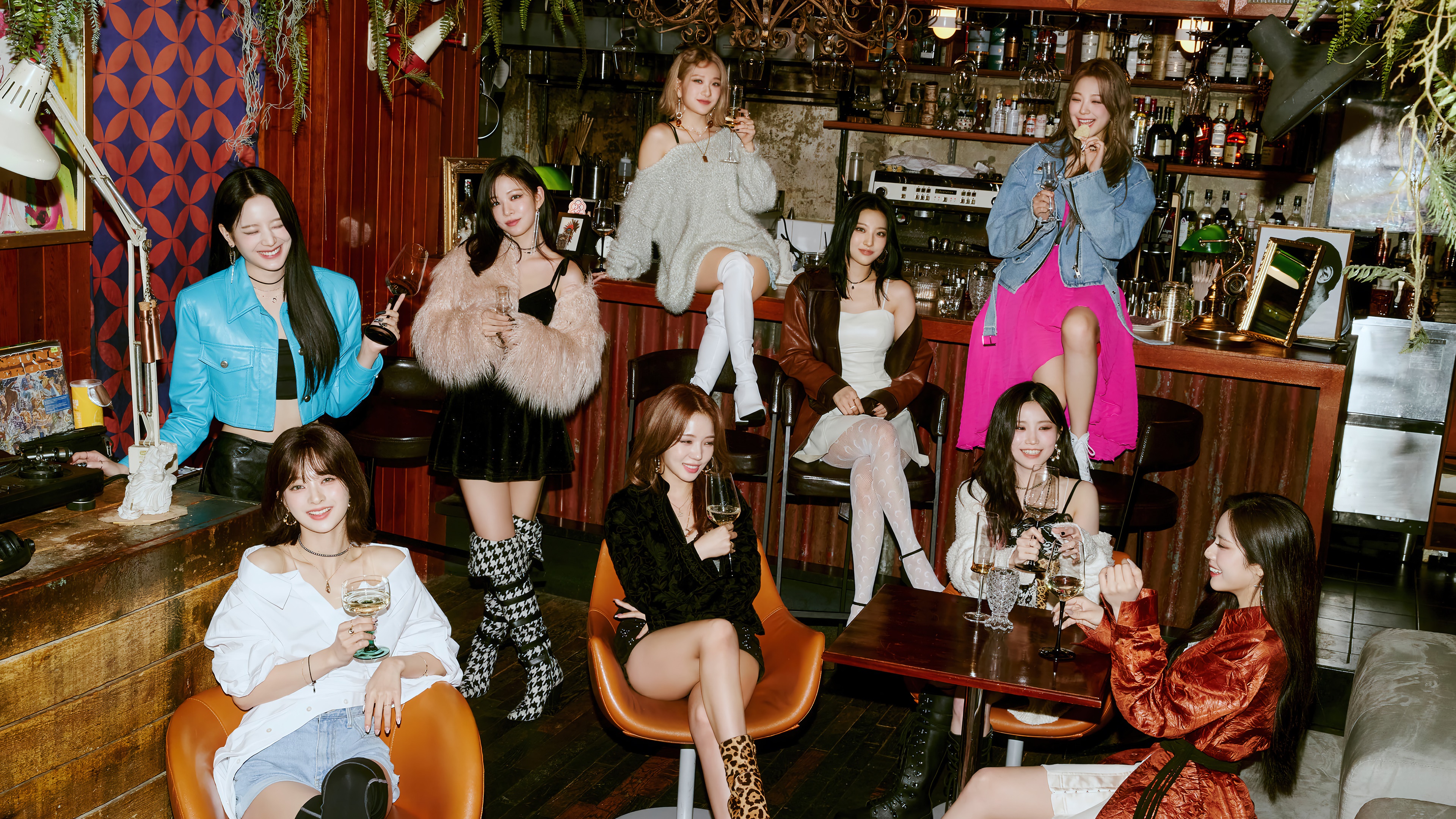 fromis_9 members in a bar setting 4K HD Wallpaper