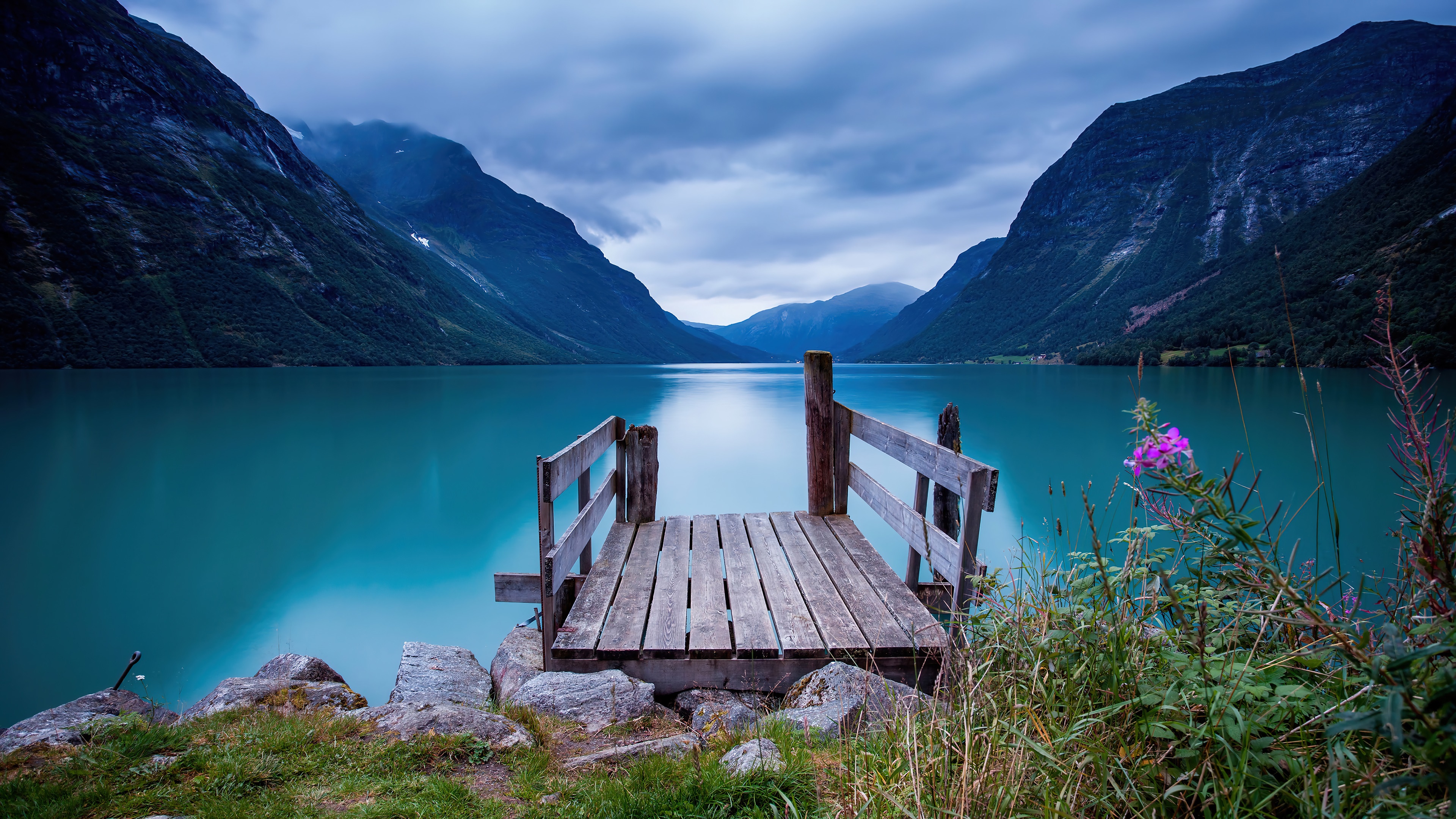 Wooden dock on a Norwegian lake with mountains HD Wallpaper