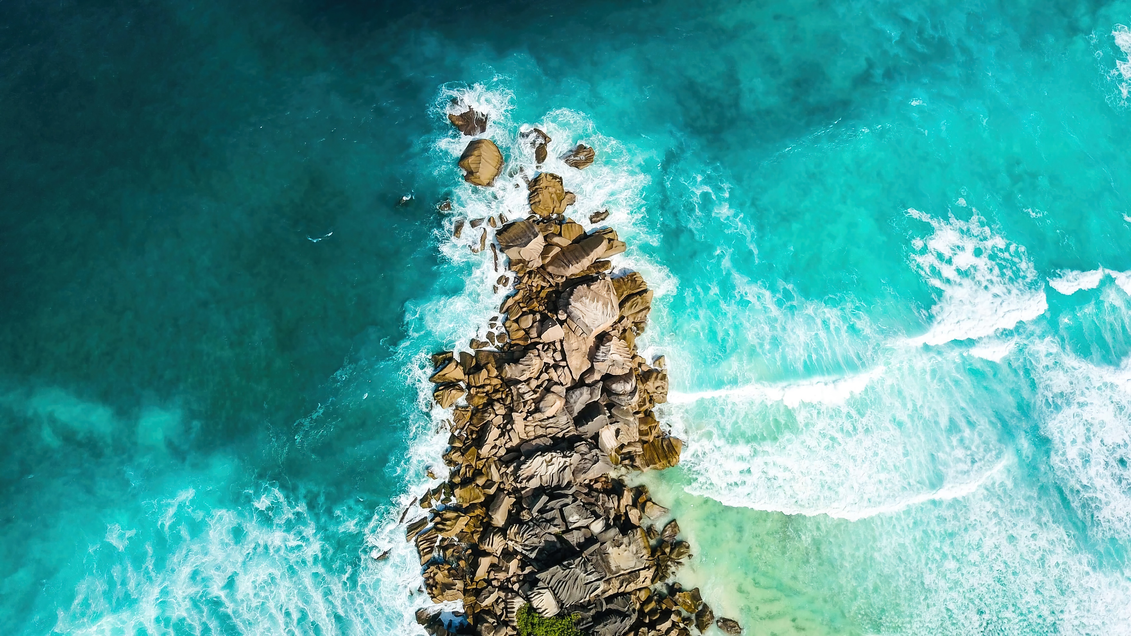 Aerial view of rocky island in turquoise sea 4K HD Wallpaper