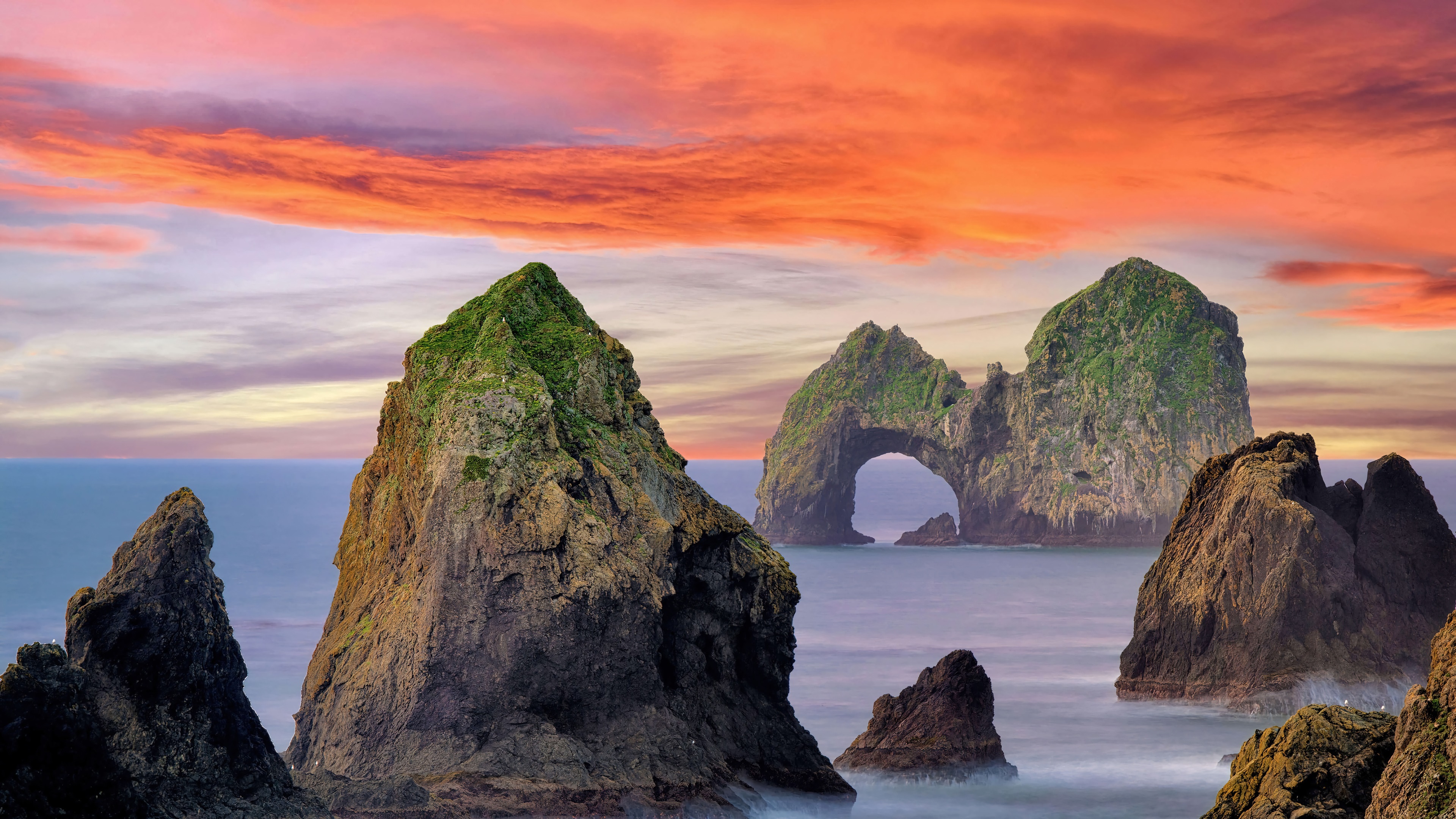 Rocky islands in the ocean at sunset 4K HD Wallpaper
