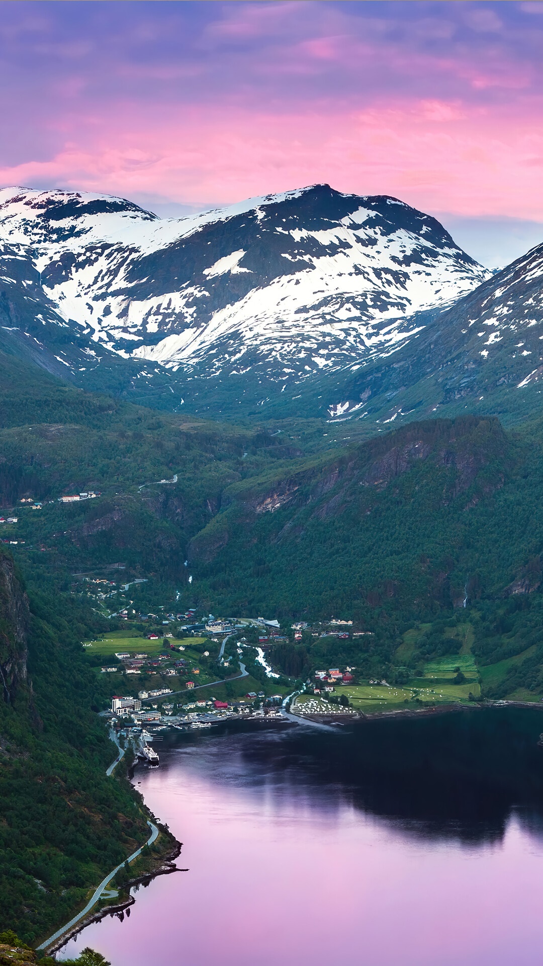 Snow-capped mountains overlooking a Norwegian fjord town HD Phone Wallpaper