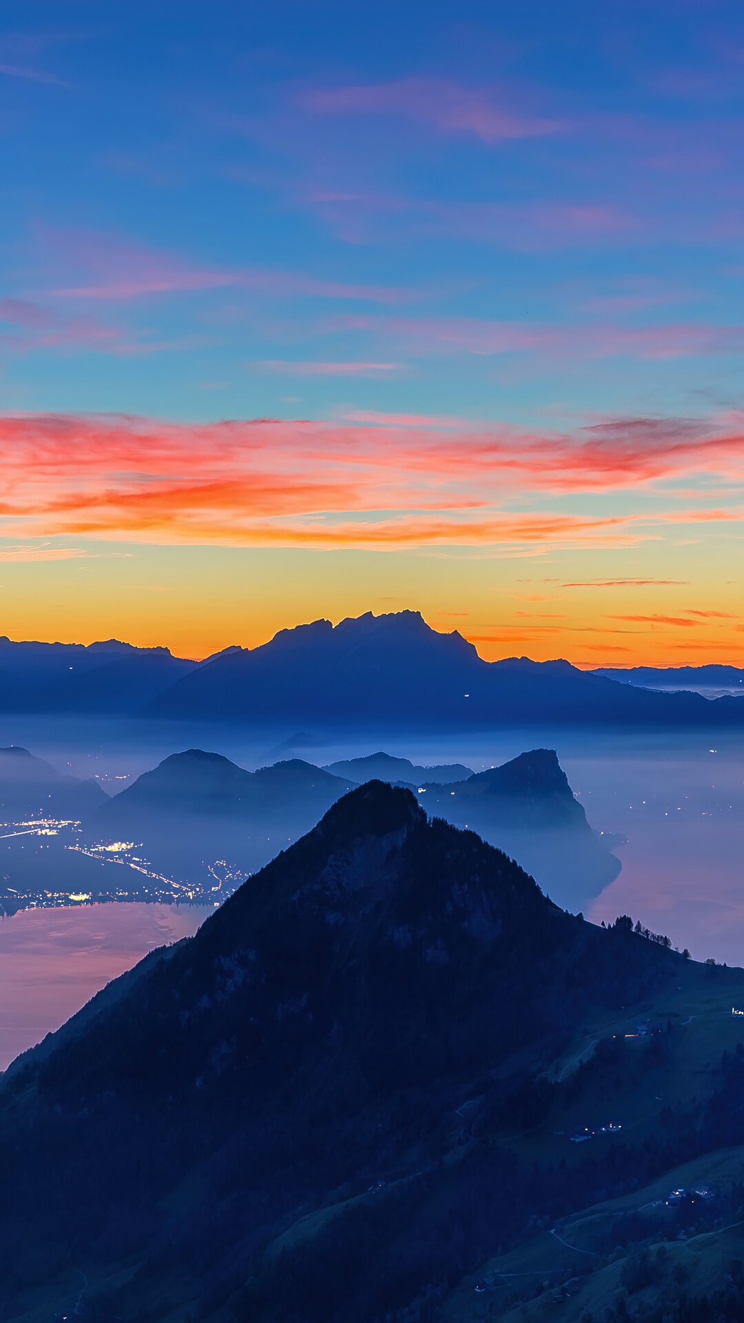 Mountain range at sunrise with lake and city lights HD Phone Wallpaper