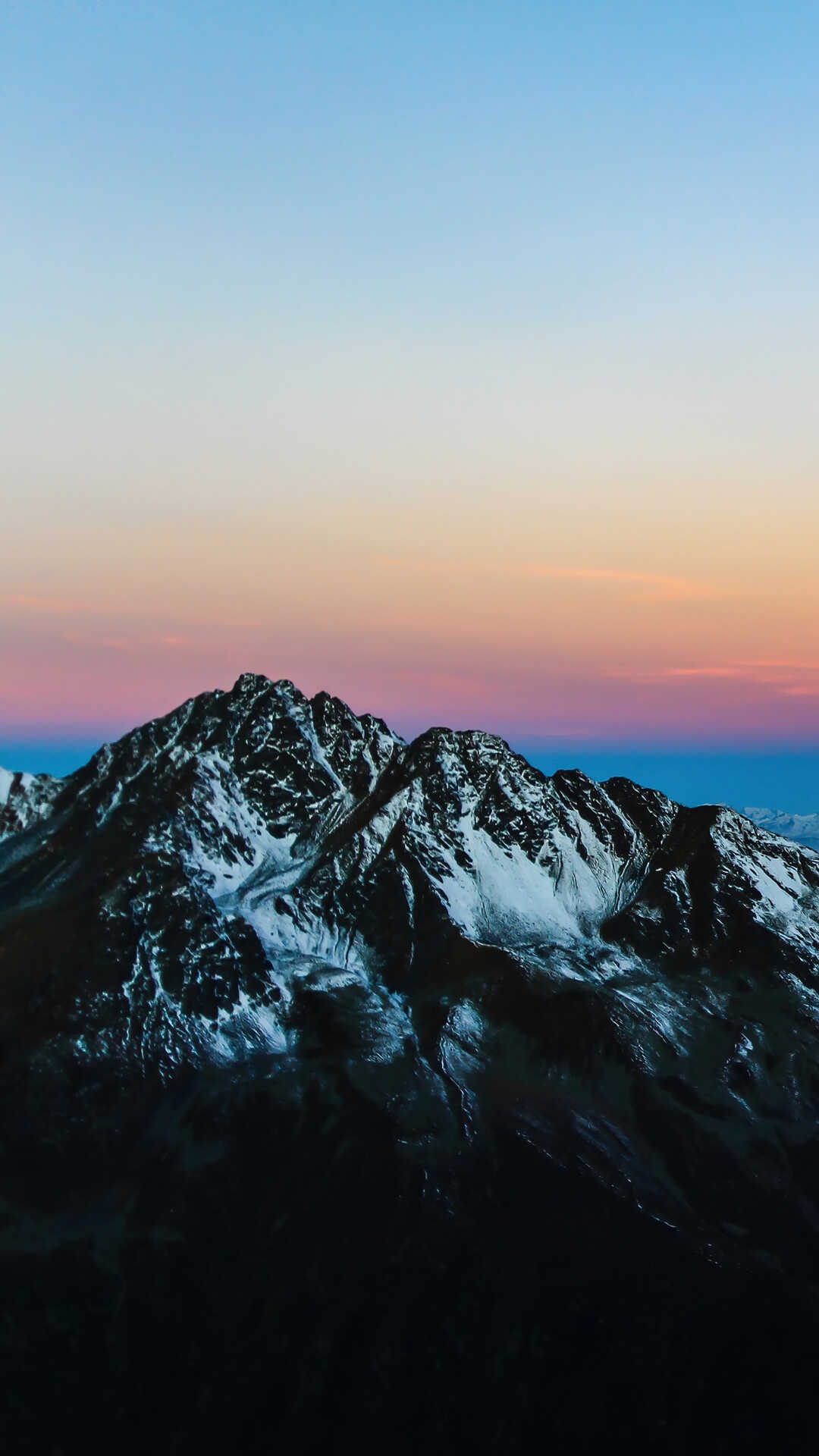 Snow-capped mountains at sunrise with colorful sky HD Phone Wallpaper