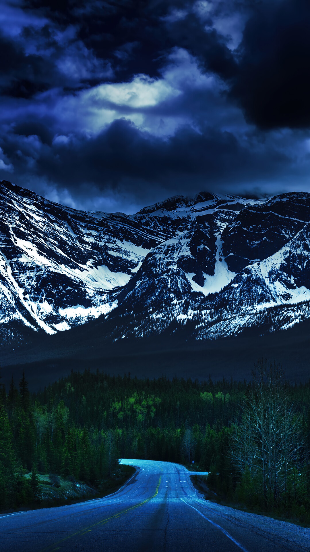 Road leading to snow-capped mountains under stormy clouds HD Phone Wallpaper
