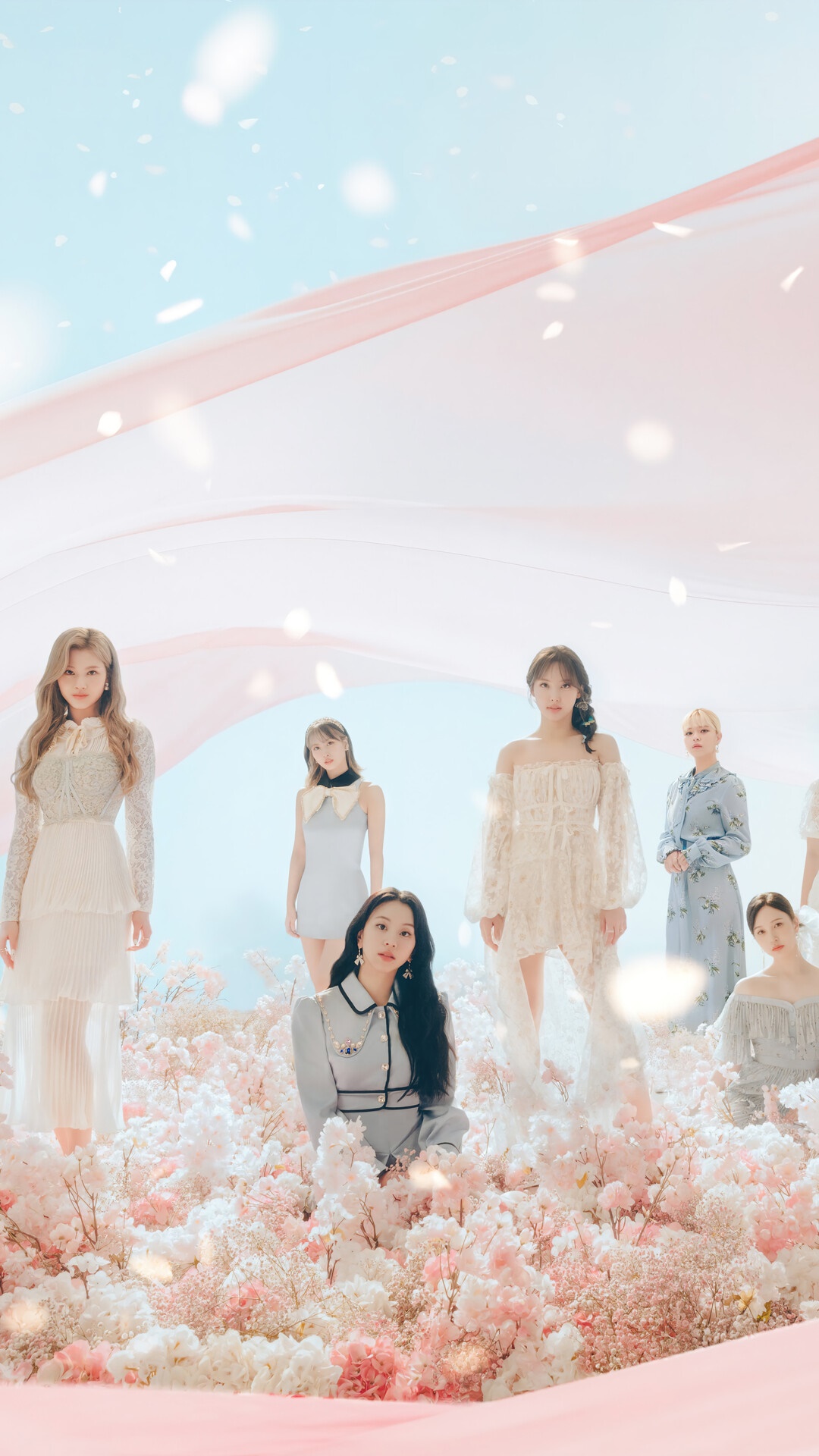 TWICE members in a floral and pastel setting HD Phone Wallpaper
