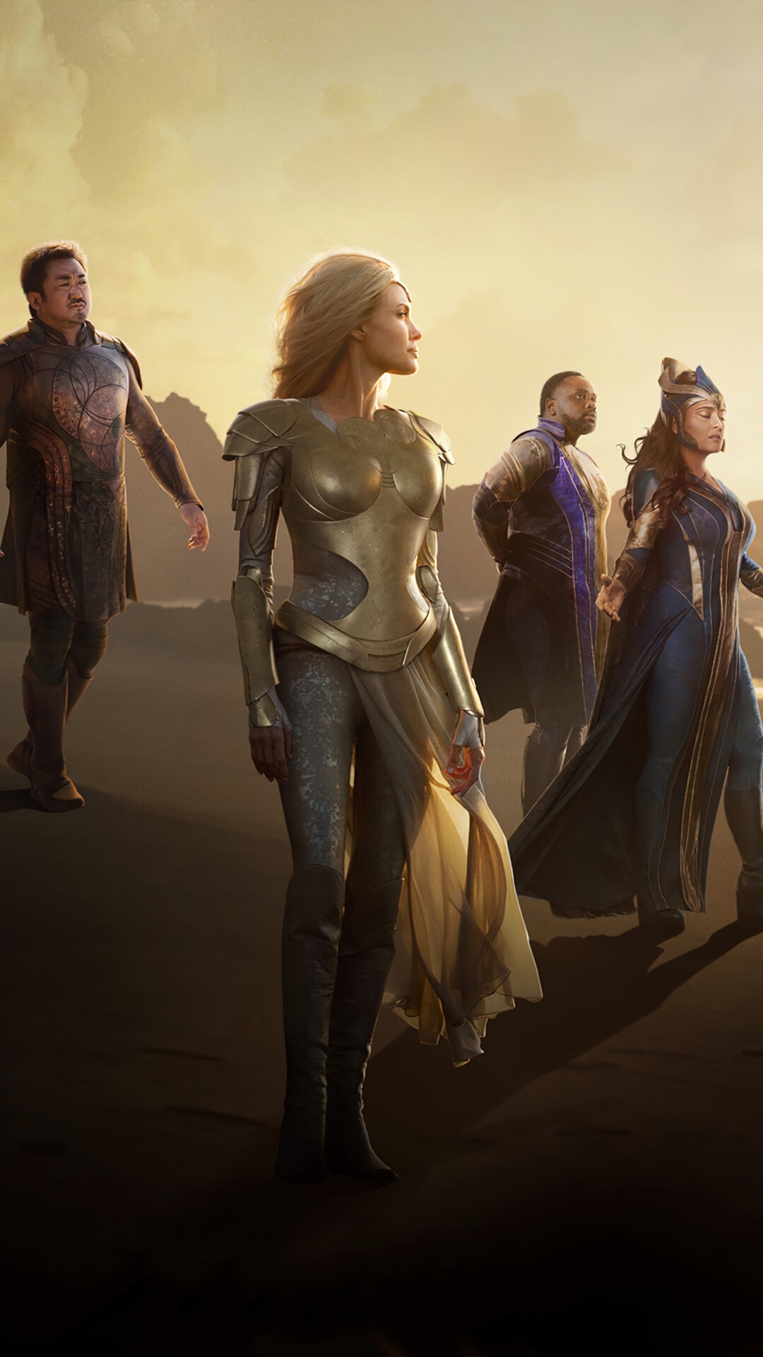 The Eternals standing on a beach at sunset HD Phone Wallpaper
