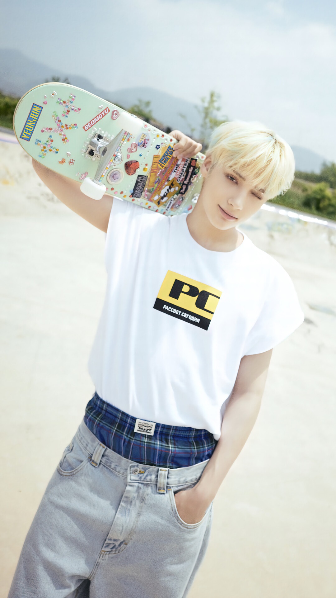Huening Kai from TXT holding a skateboard HD Phone Wallpaper