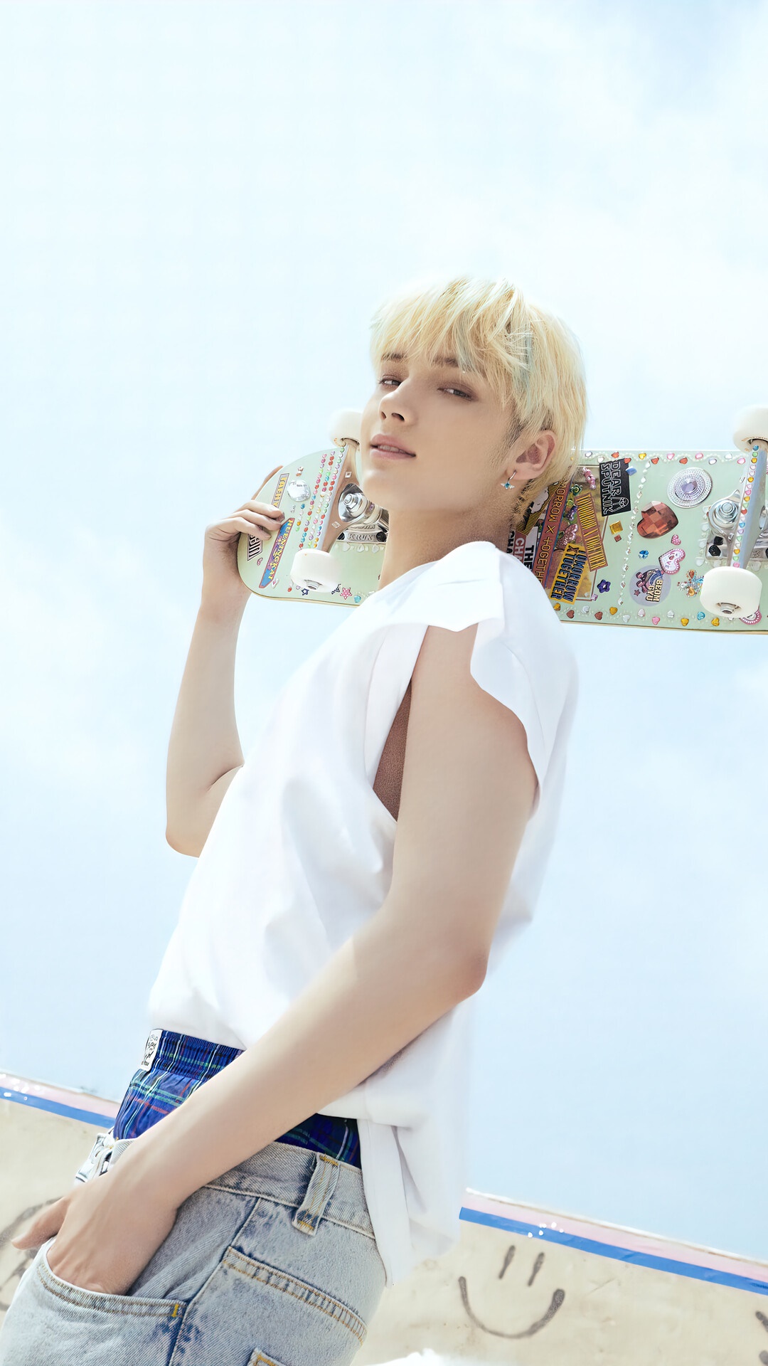 Huening Kai from TXT holding a skateboard HD Phone Wallpaper