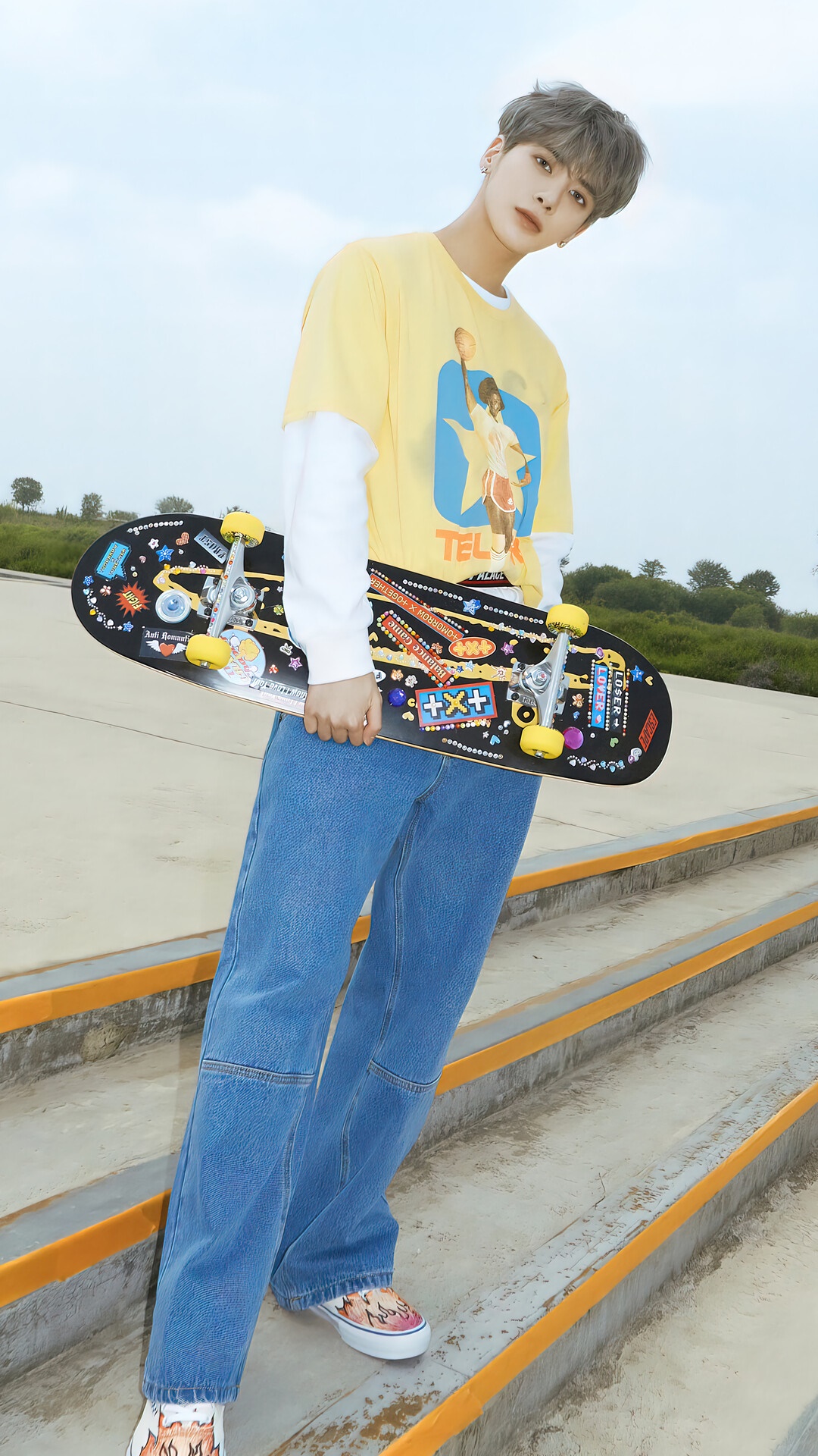 Taehyun from TXT holding a skateboard HD Phone Wallpaper
