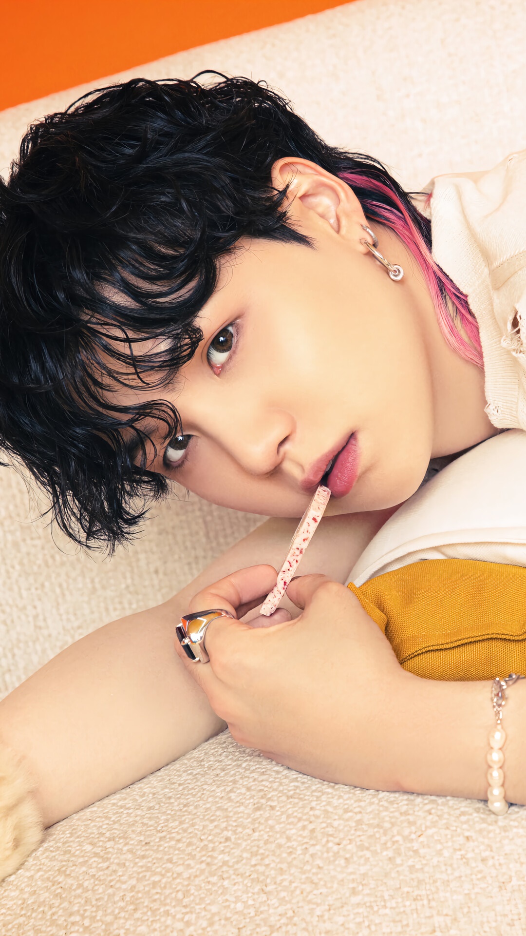 Suga from BTS holding a pink candy stick HD Phone Wallpaper