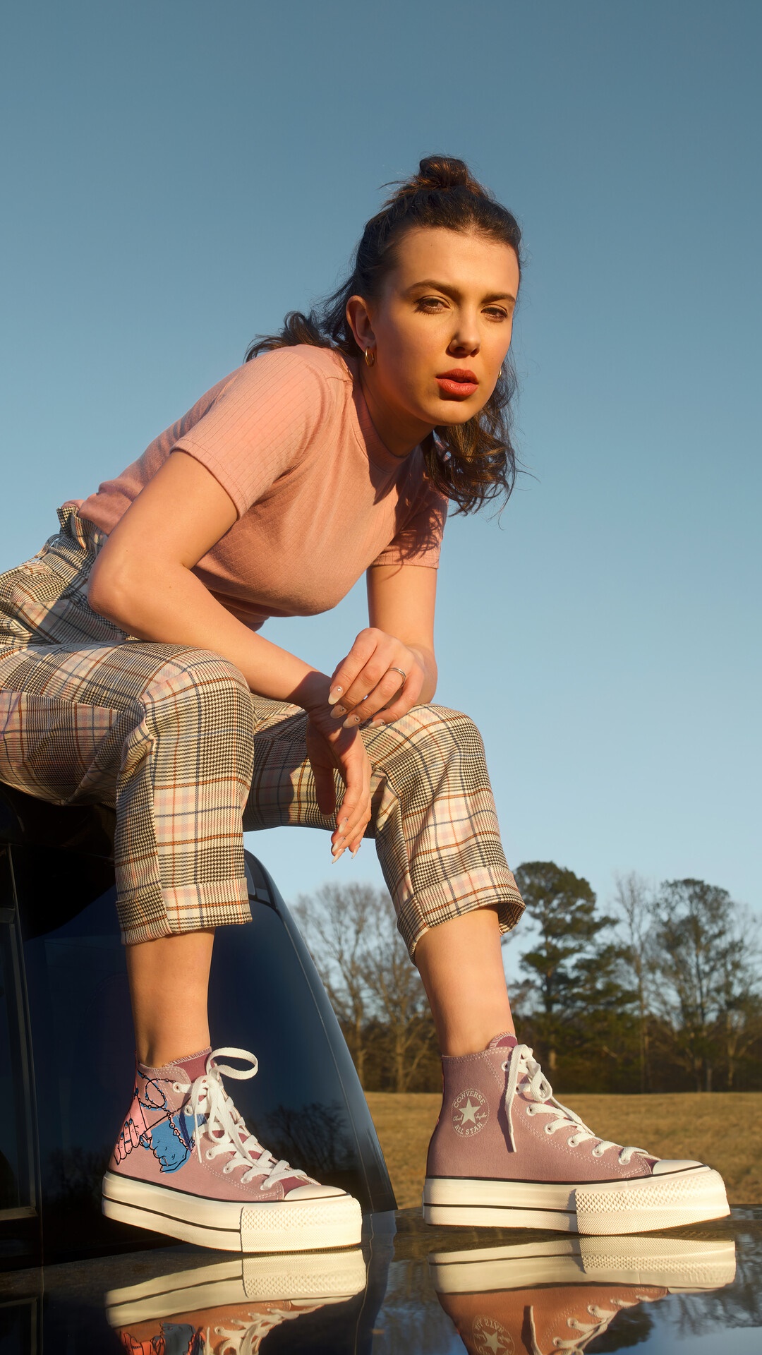 Millie Bobby Brown posing outdoors HD Phone Wallpaper