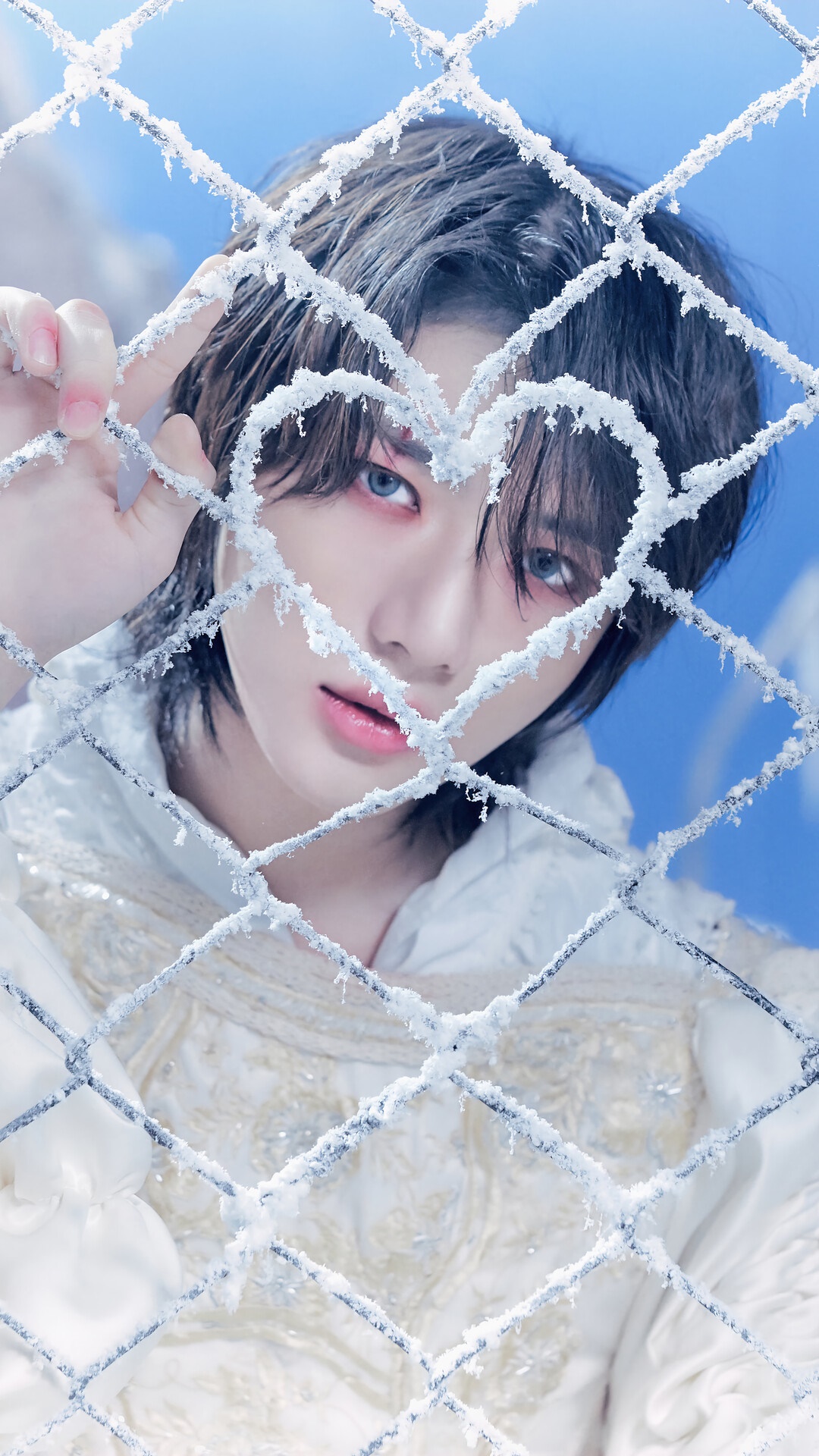 Beomgyu from TXT behind a frosted heart fence HD Phone Wallpaper