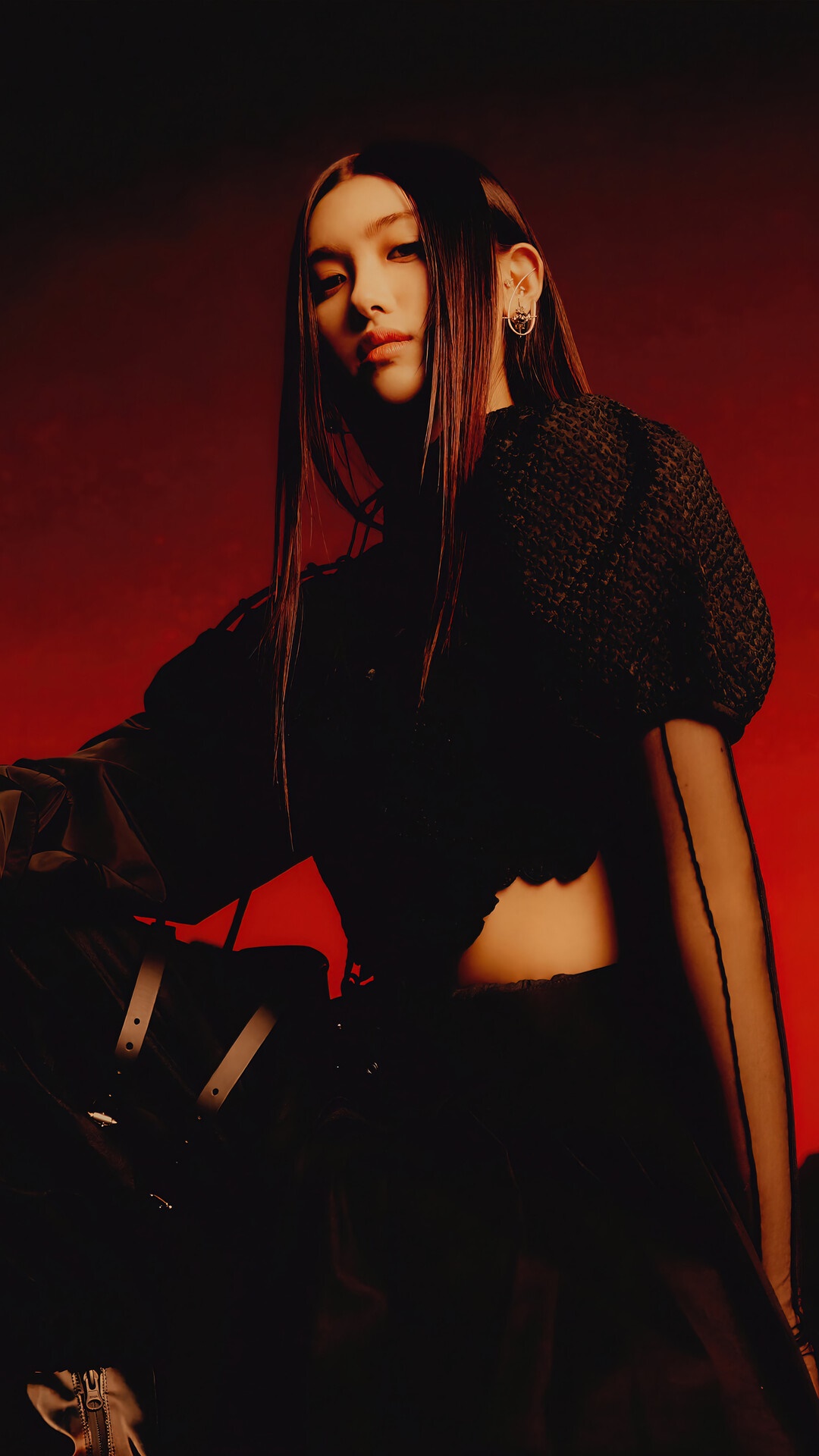 Aisha from EVERGLOW posing against a red background HD Phone Wallpaper