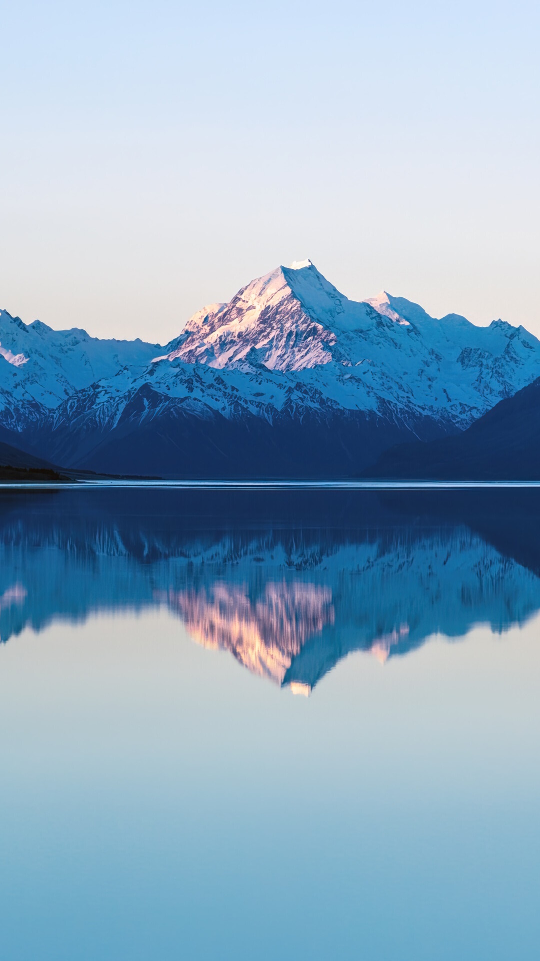 Snow-capped mountains reflected in a calm lake HD Phone Wallpaper