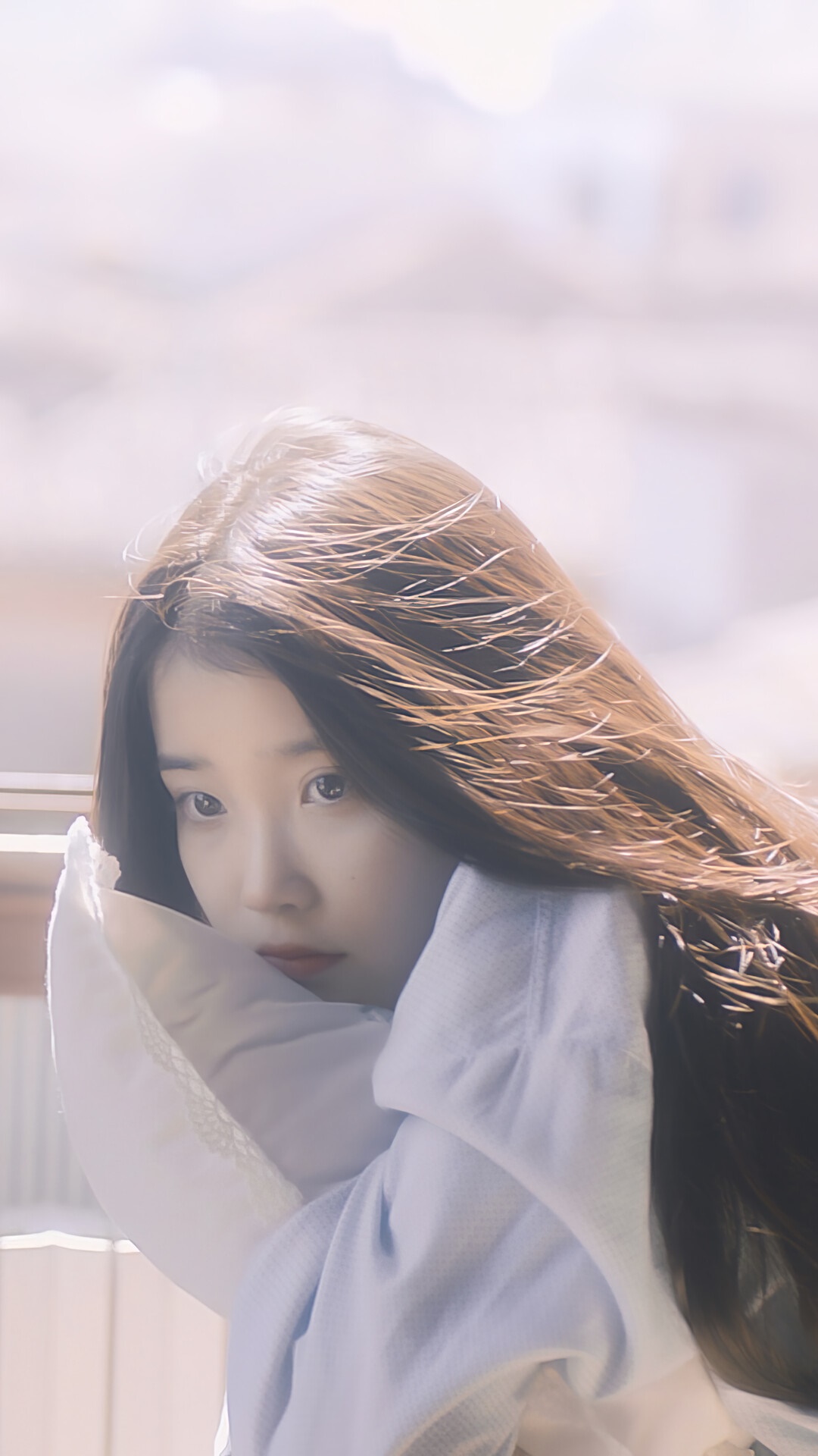 IU (Lee Ji Eun) posing with a pillow HD Phone Wallpaper