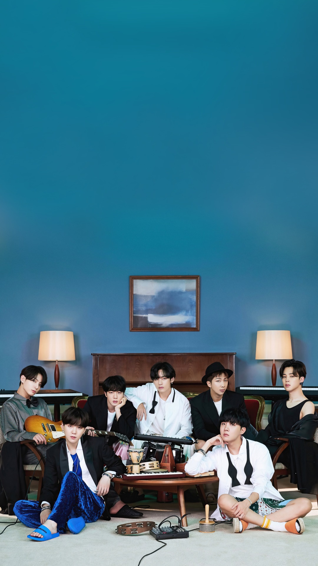 BTS members posing in a room with blue walls HD Phone Wallpaper