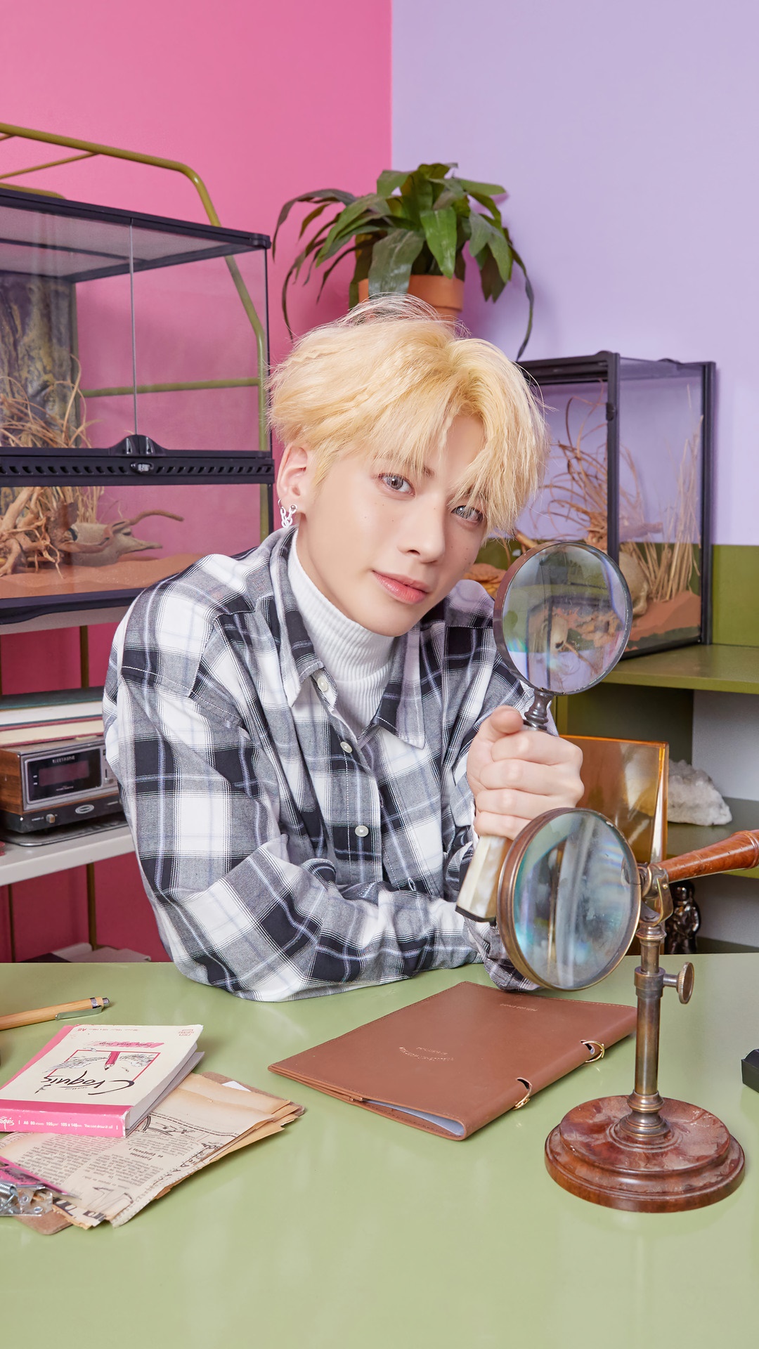 Taehyun from TXT holding magnifying glasses HD Phone Wallpaper