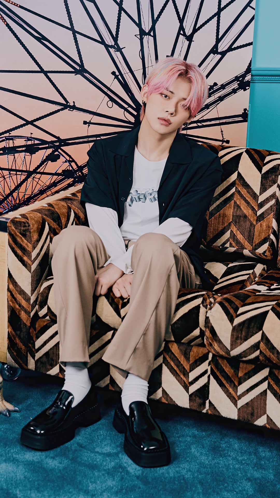 Yeonjun from TXT posing on a couch HD Phone Wallpaper