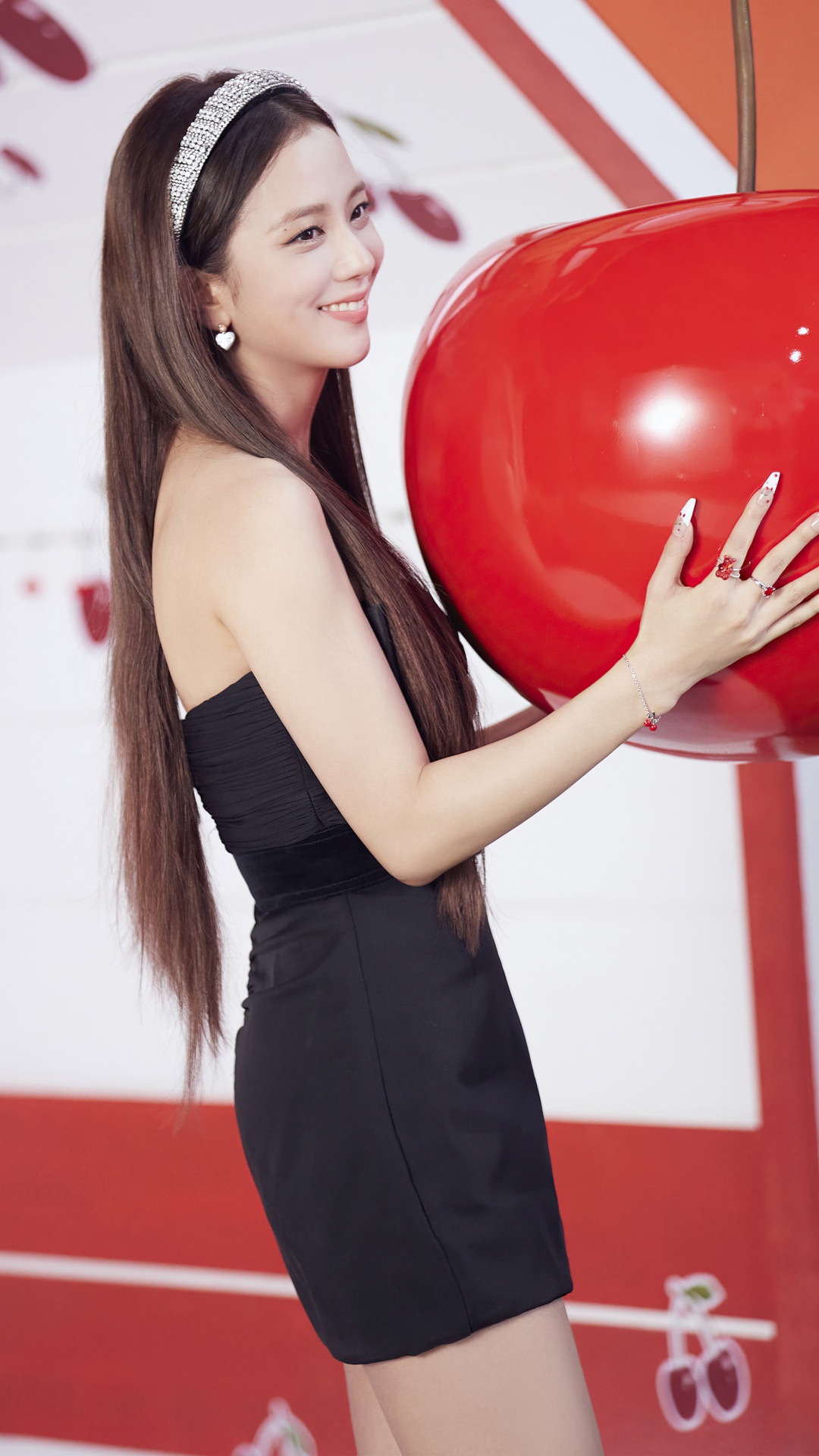 Jisoo from BLACKPINK holding a giant cherry HD Phone Wallpaper