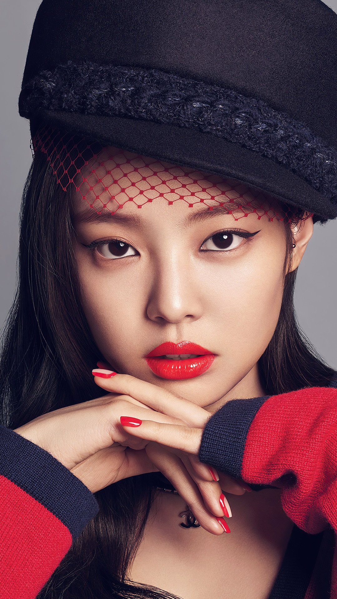 Jennie from BLACKPINK wearing a black hat and red sweater HD Phone Wallpaper