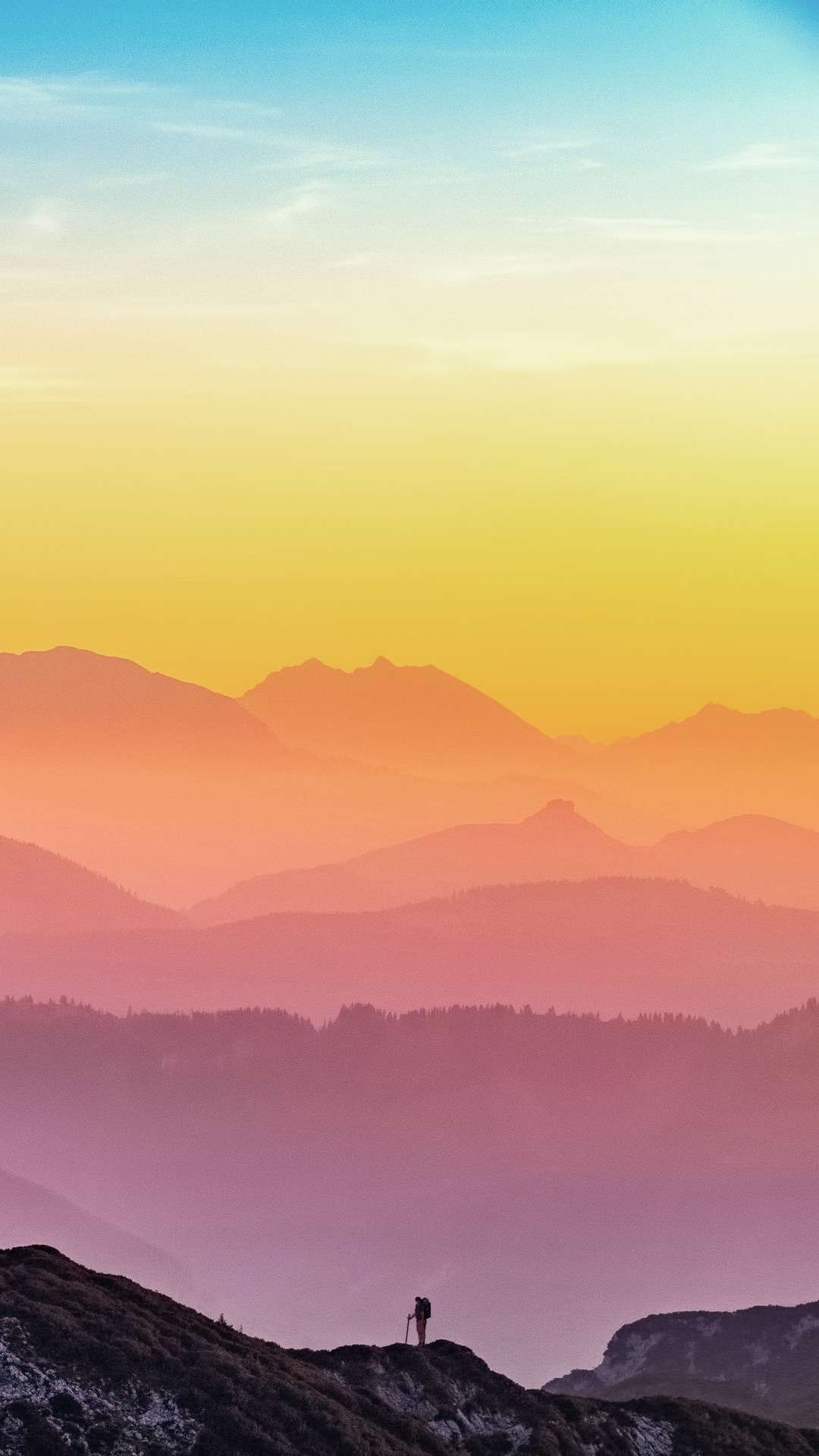 Hiker on mountain ridge with layered mountains at sunset HD Phone Wallpaper