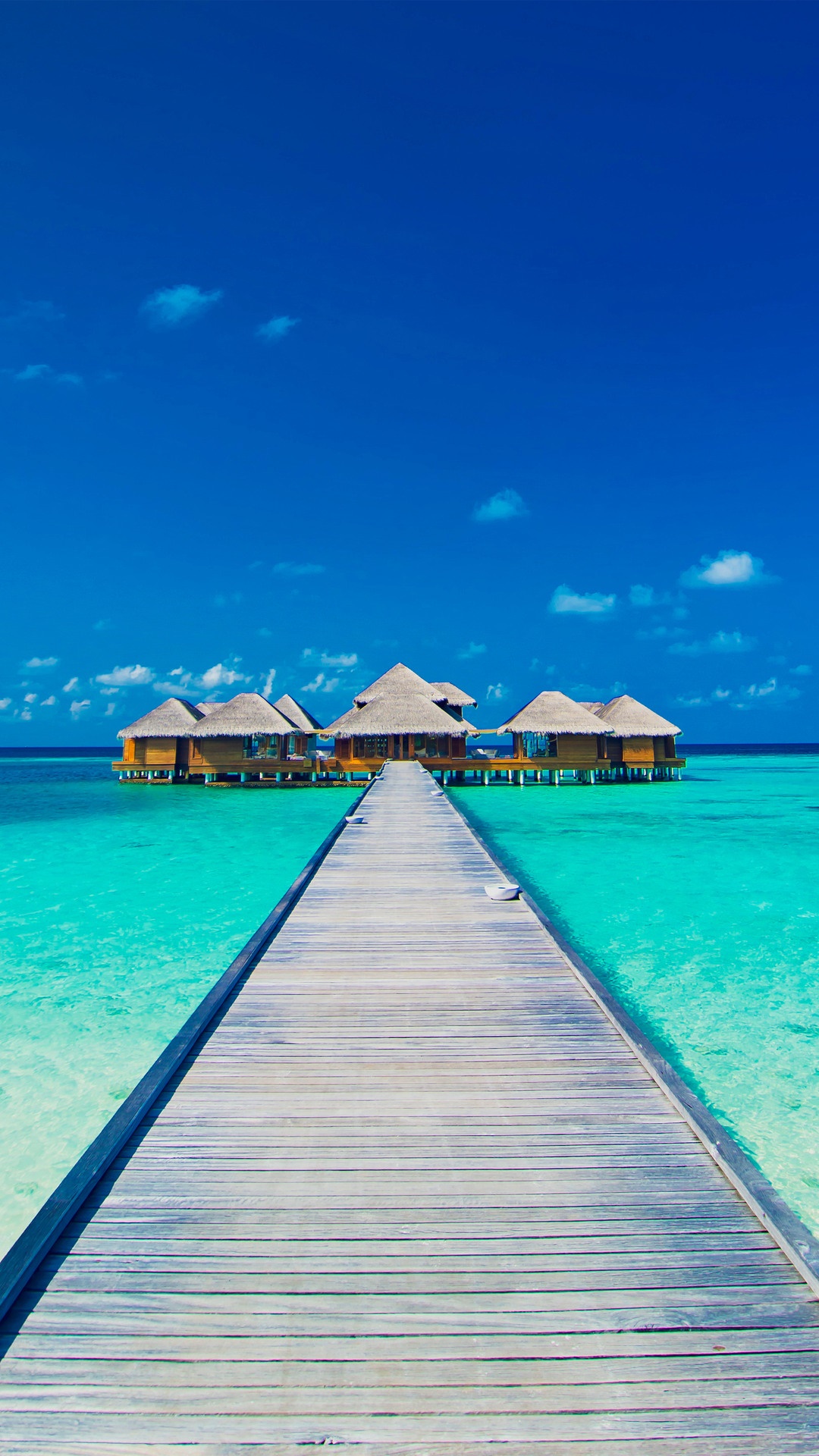 Wooden pier leading to overwater bungalows in the Maldives HD Phone Wallpaper