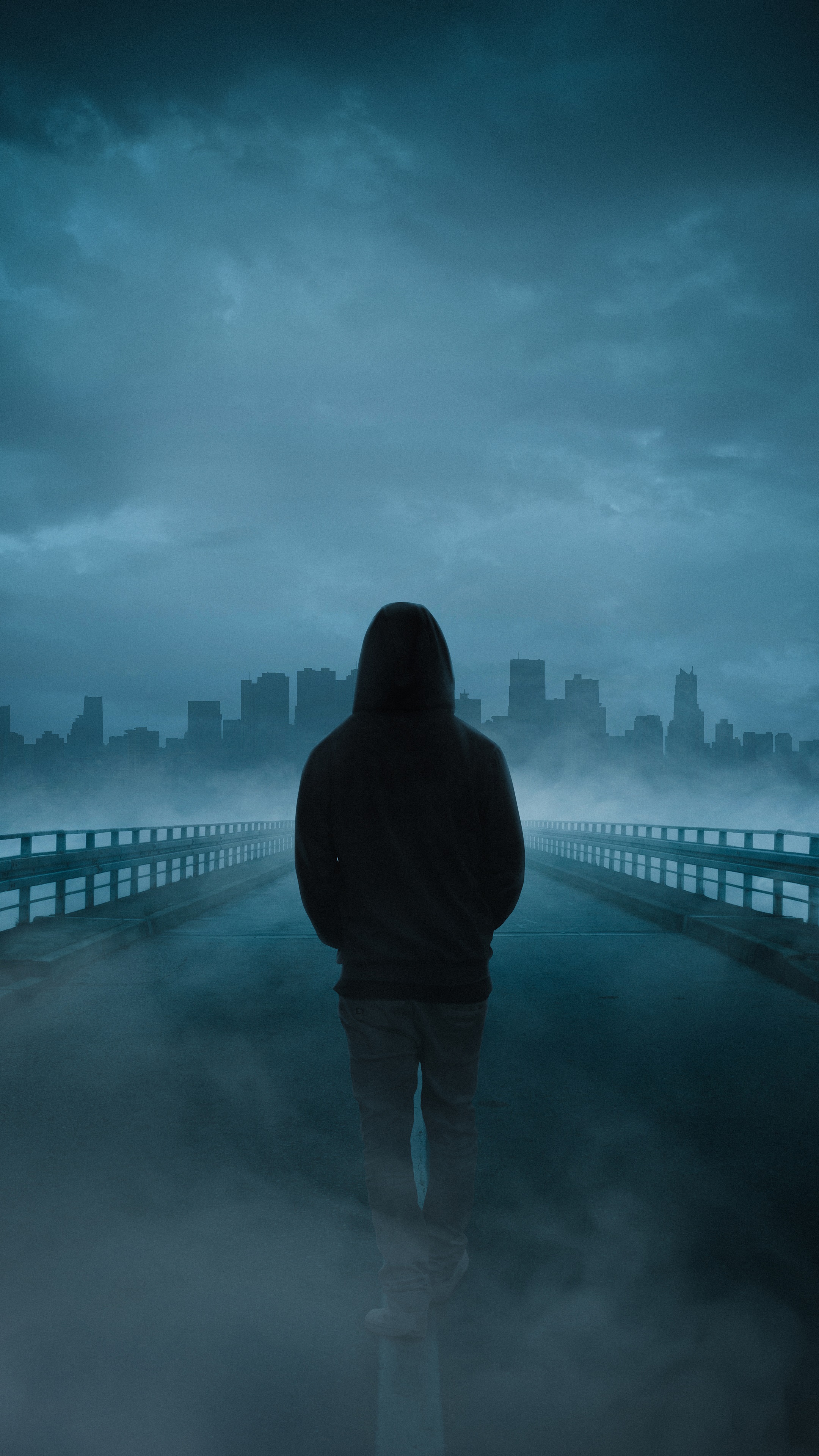 Person in hoodie on bridge with city skyline HD Phone Wallpaper