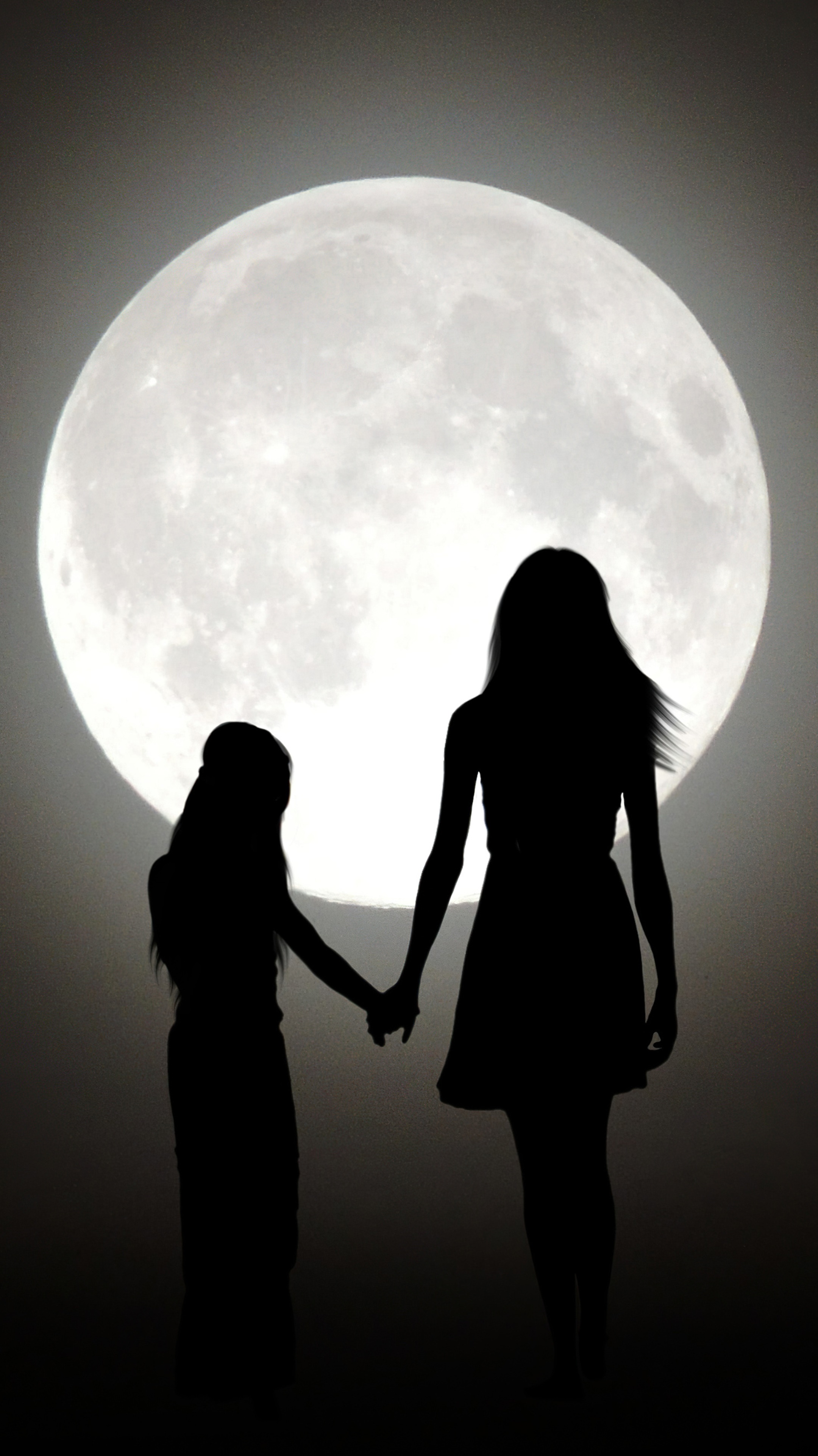 Two figures silhouetted against a large moon HD Phone Wallpaper