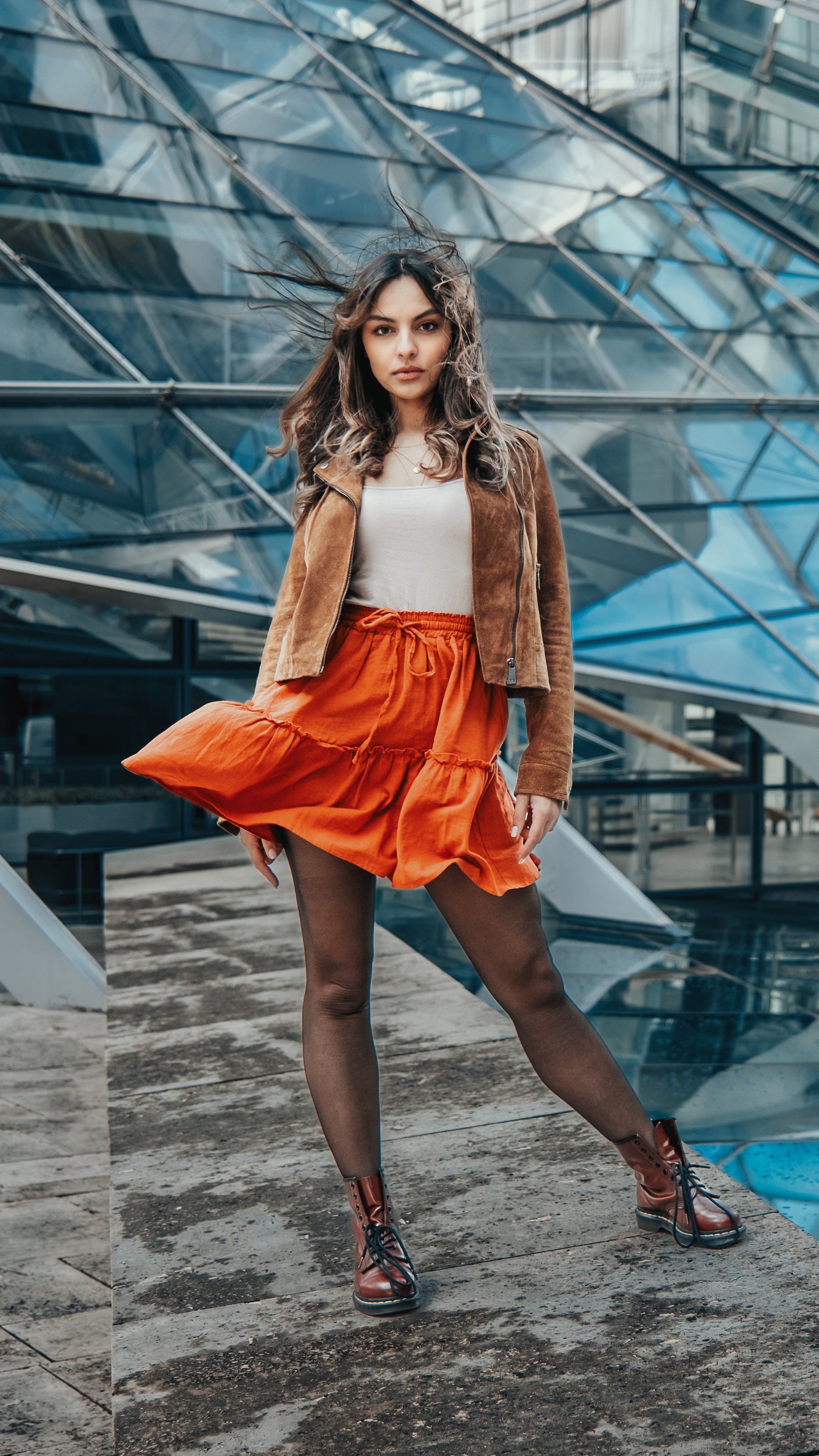 Model in orange skirt and brown jacket HD Phone Wallpaper