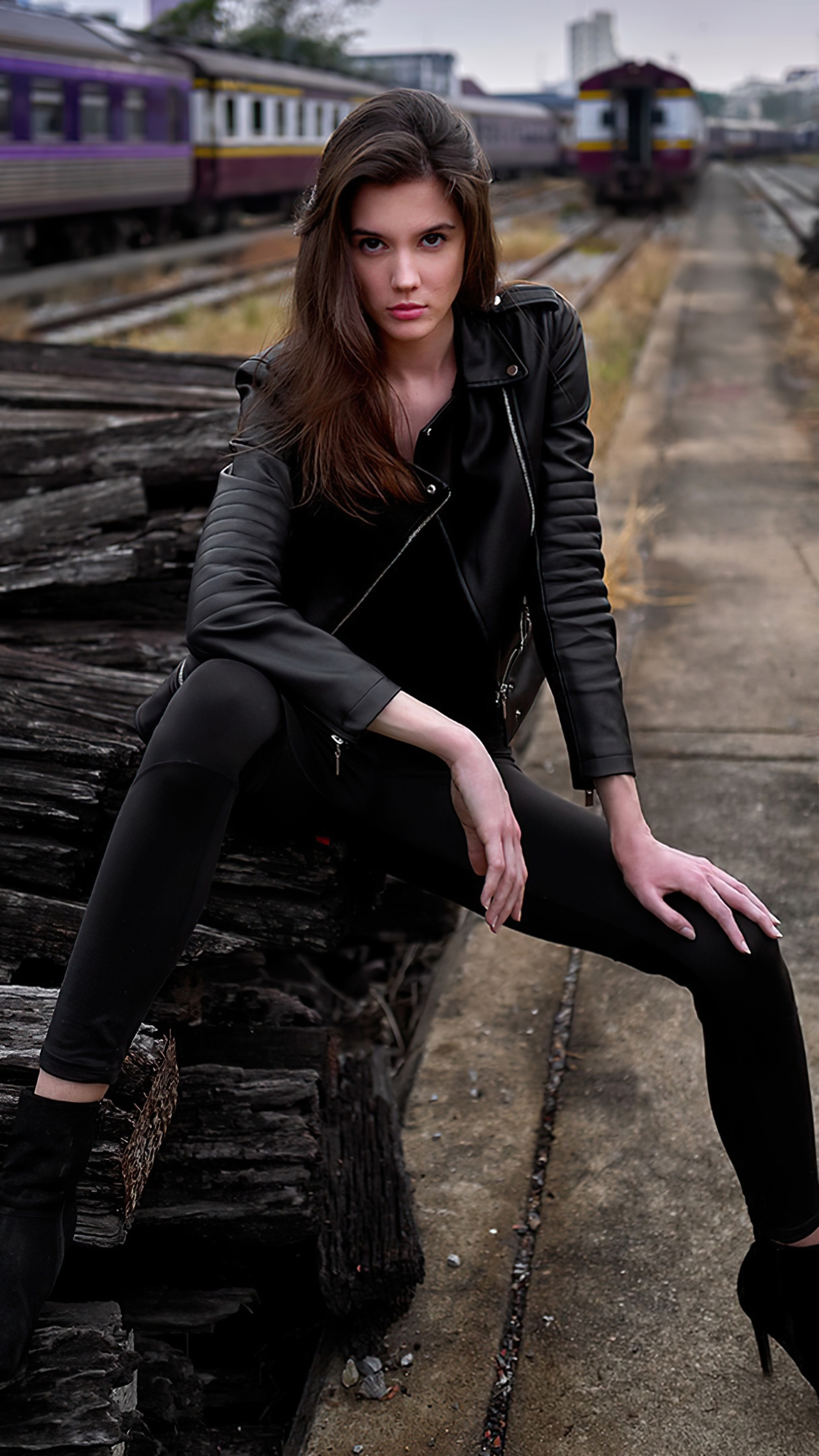 Model in black leather jacket at train station HD Phone Wallpaper