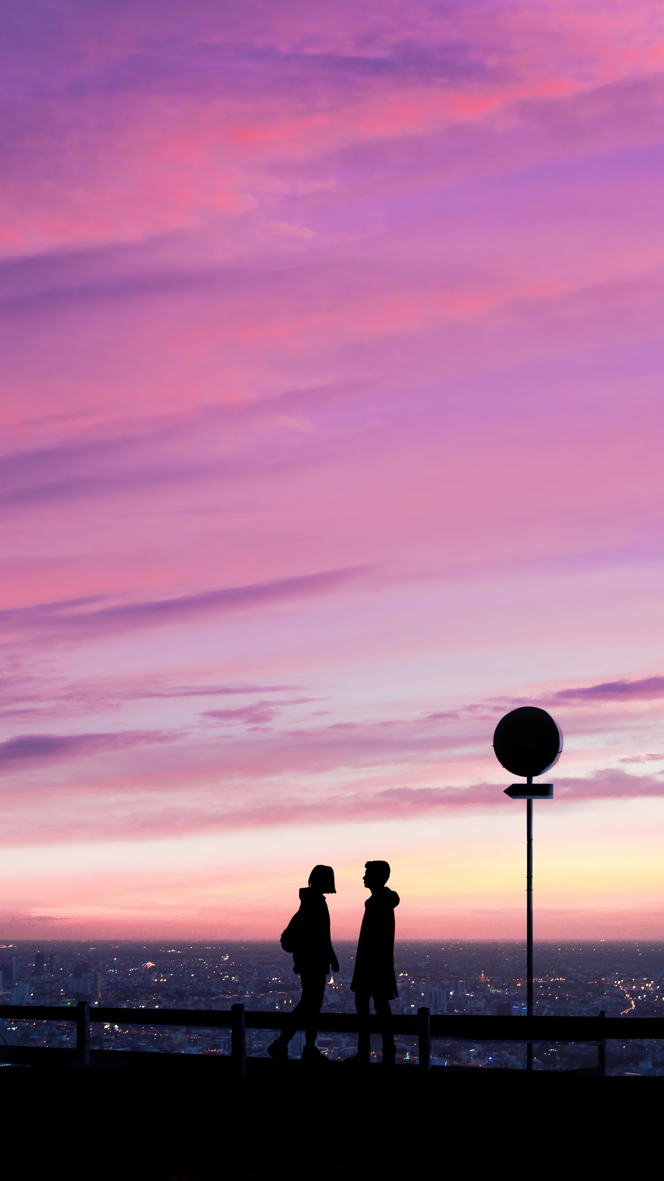Couple silhouetted against a pink and purple sunset sky HD Phone Wallpaper