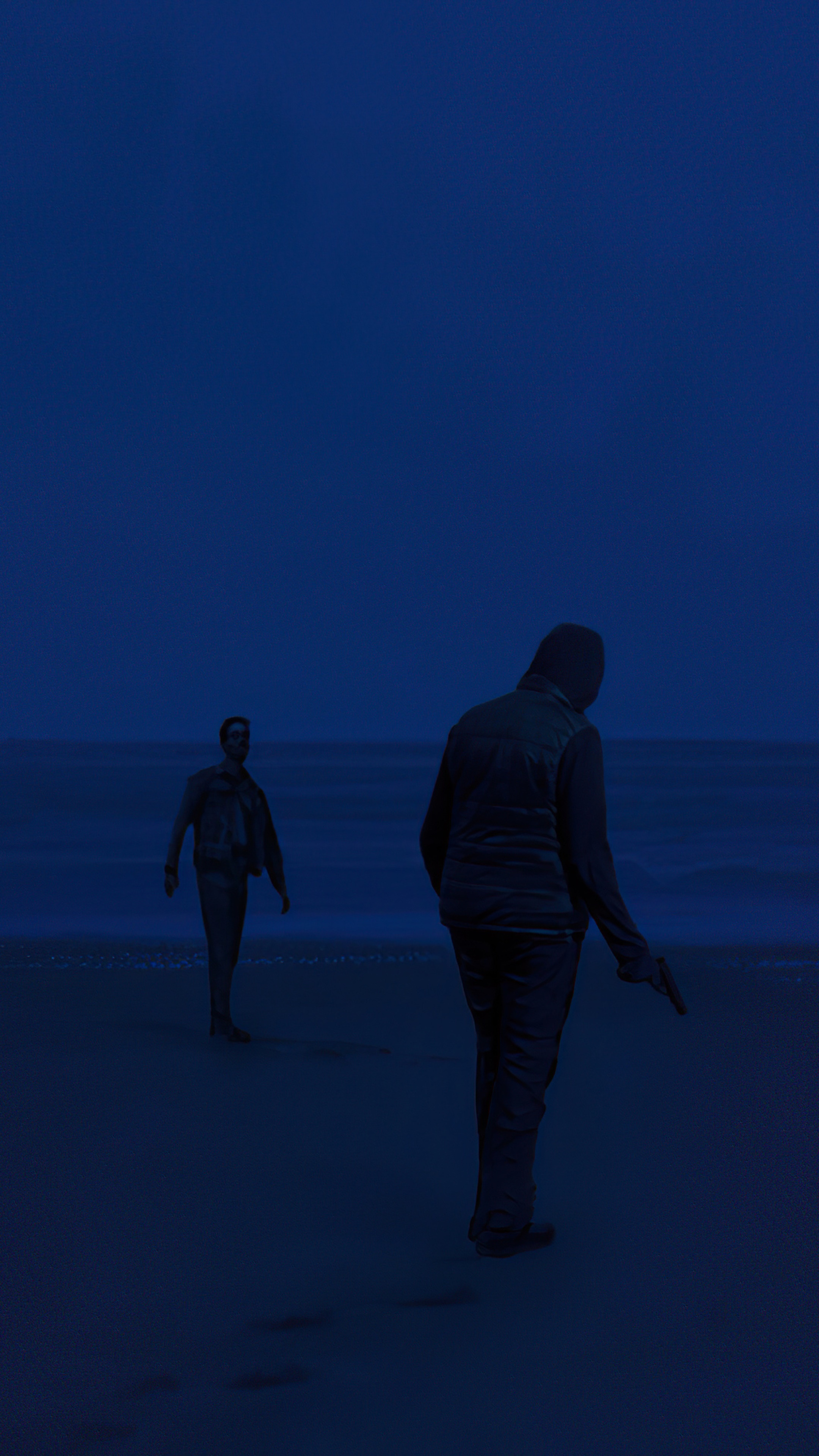 Two men on a beach at night, one holding a gun HD Phone Wallpaper