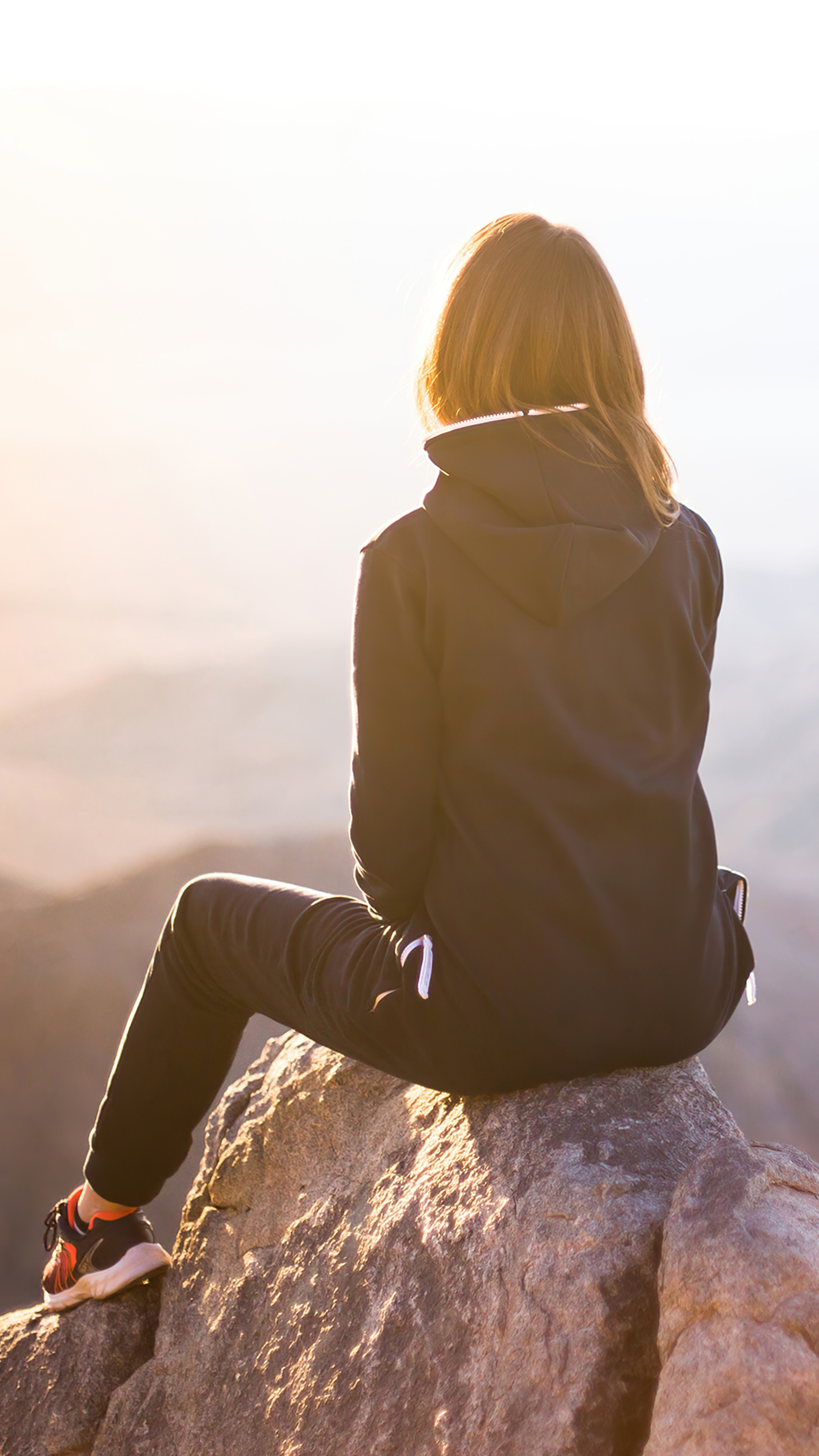 Girl sitting on a rock at sunset HD Phone Wallpaper