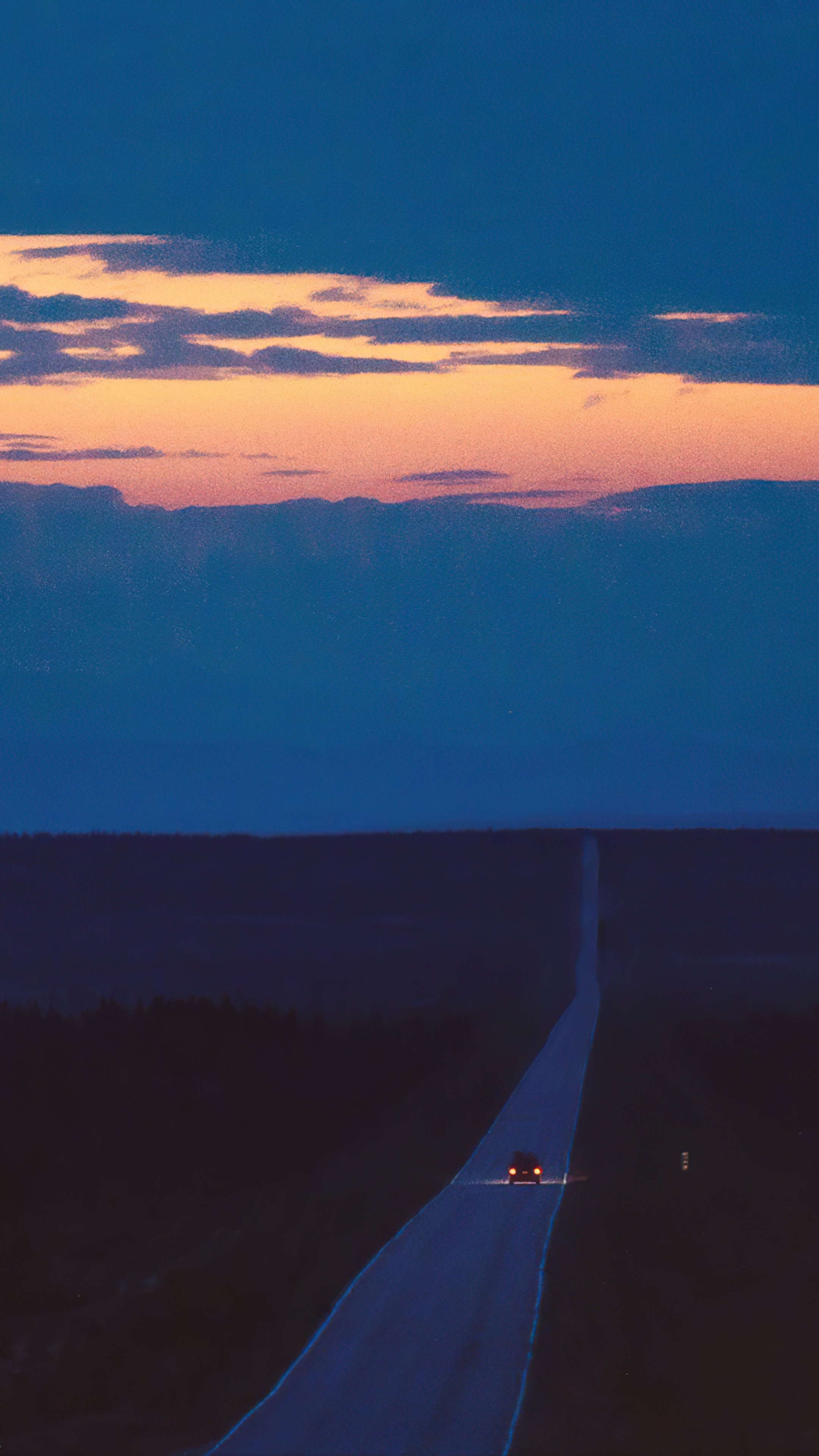 Car on a long road at dusk HD Phone Wallpaper