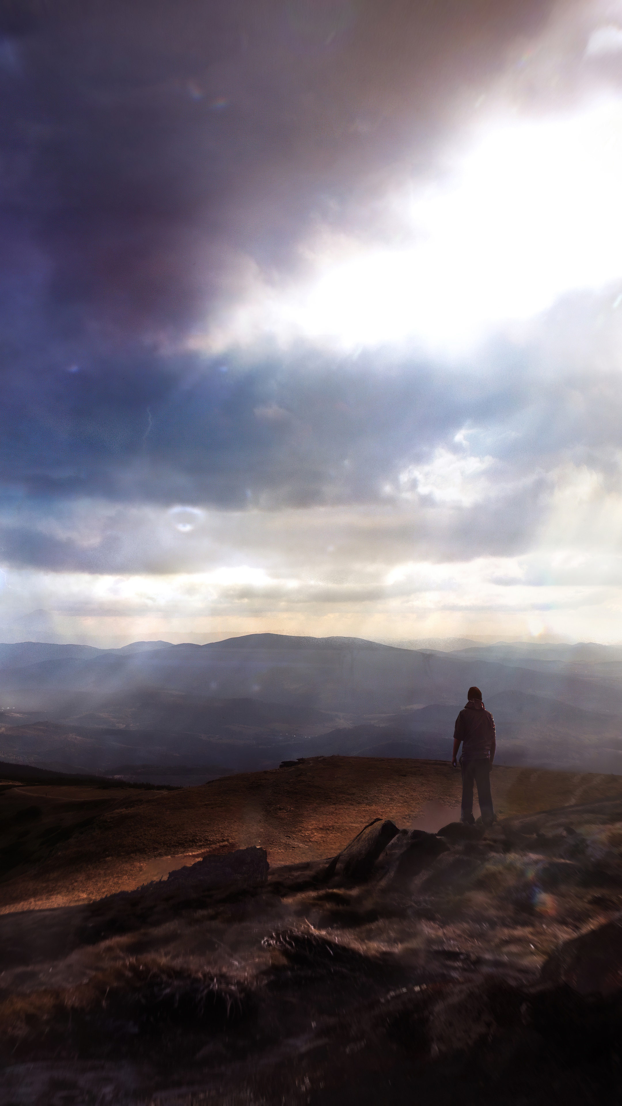 Man standing on a rocky hill overlooking mountains HD Phone Wallpaper