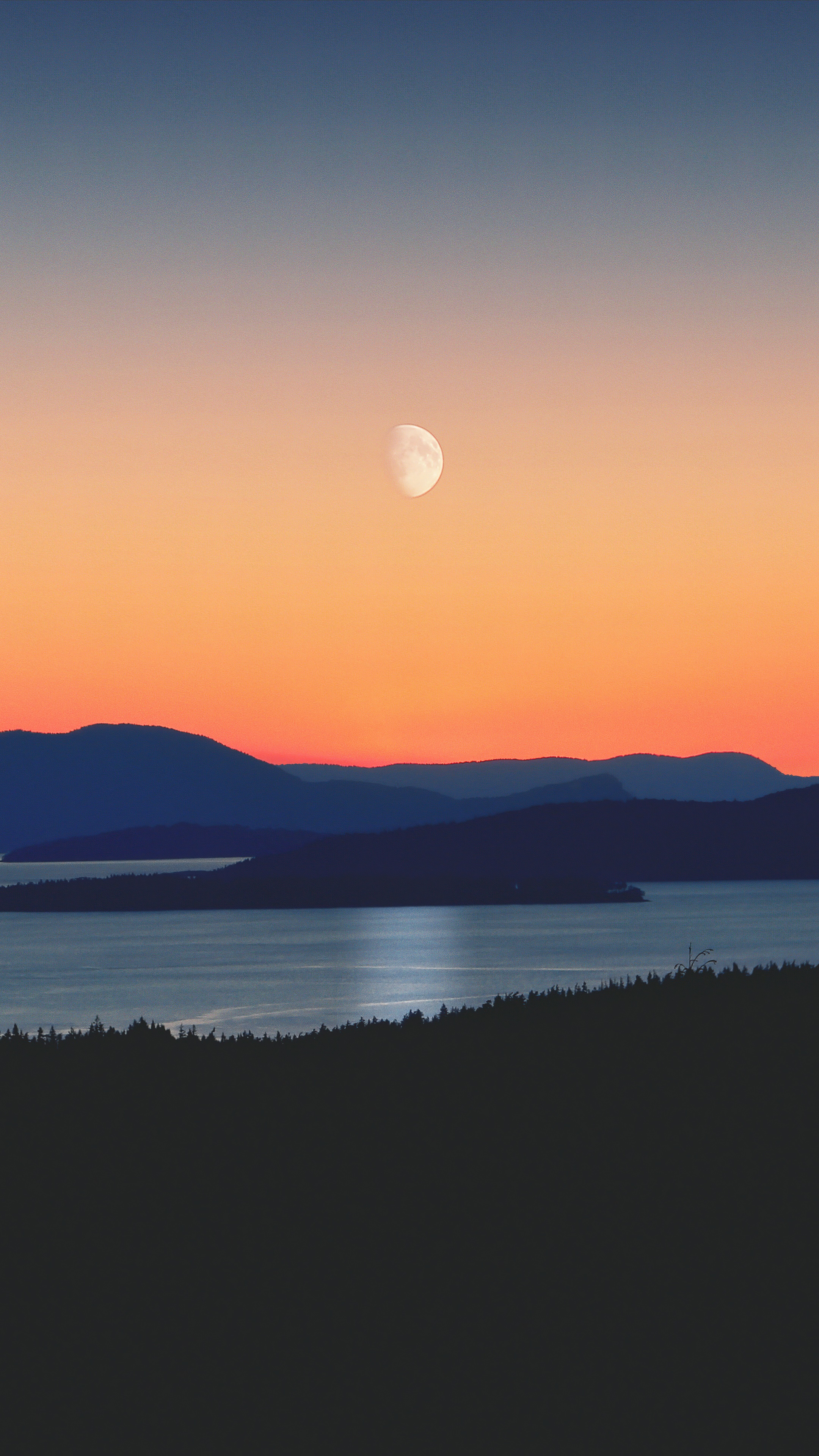 Silhouette of mountains and water at sunset with moon HD Phone Wallpaper