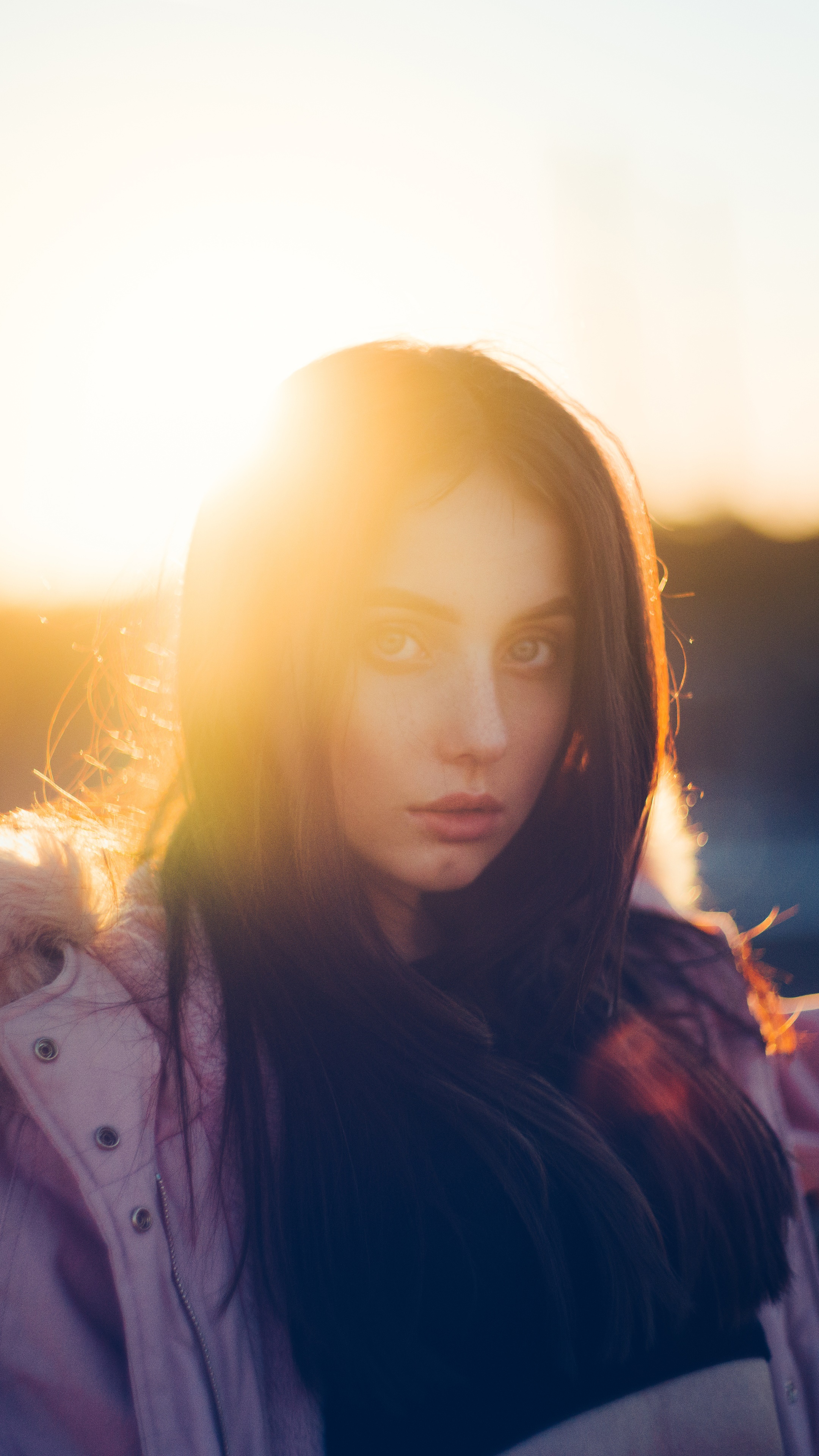 Young woman in pink jacket at sunset HD Phone Wallpaper