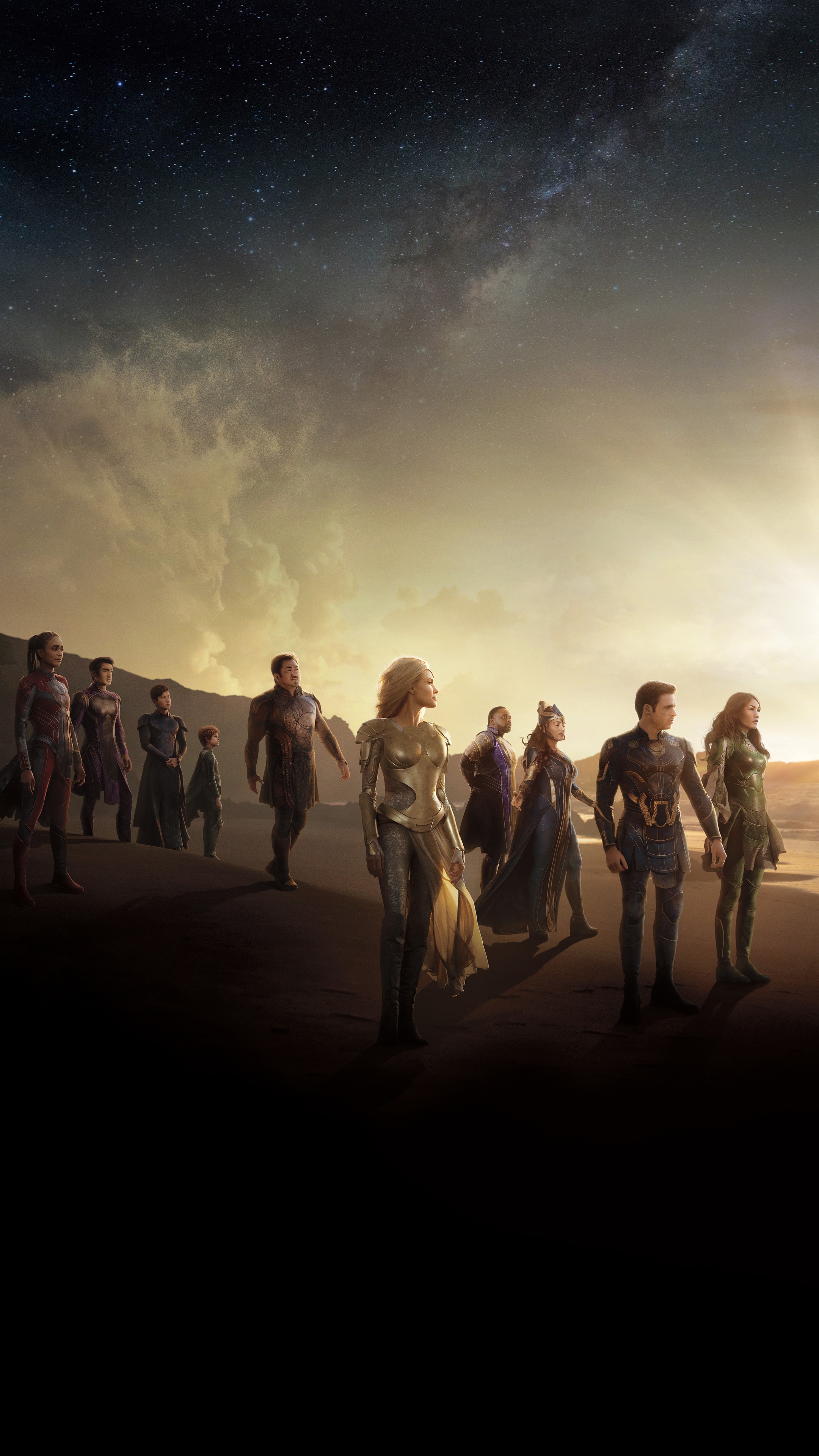 The Eternals standing on a beach at sunset HD Phone Wallpaper