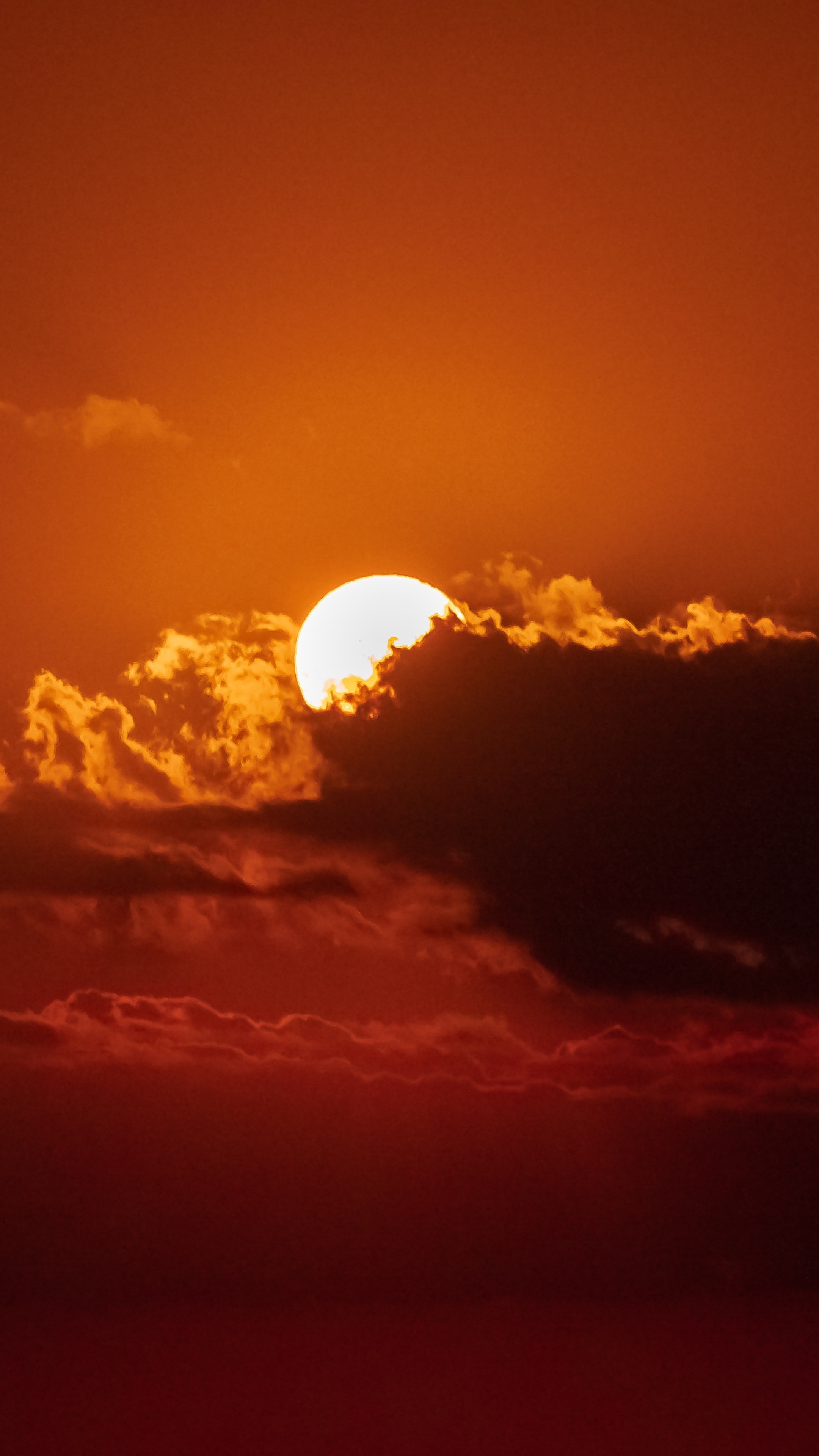 Sun behind clouds during sunset 4K HD Phone Wallpaper