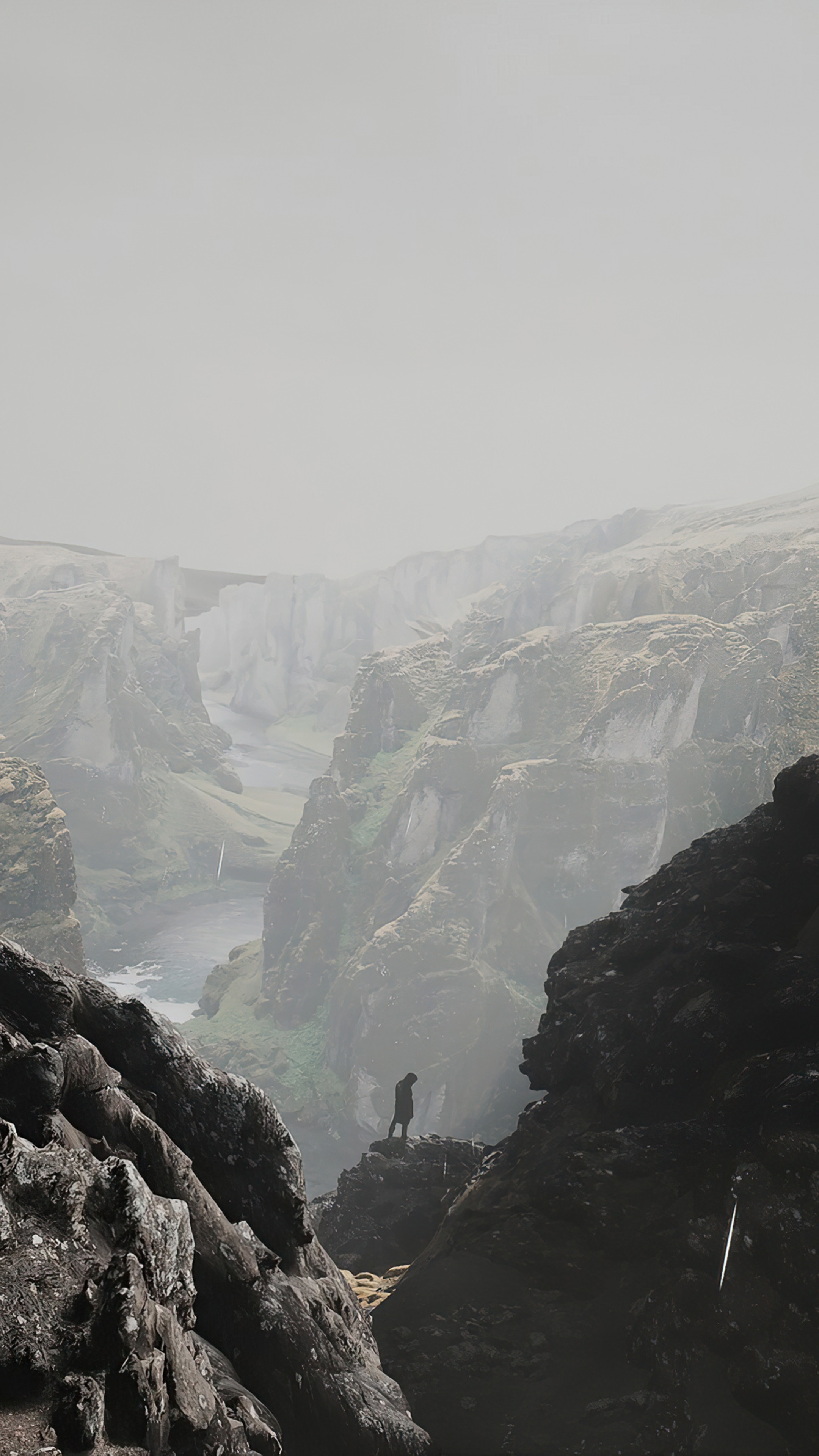 Man standing on cliff edge overlooking Icelandic canyon HD Phone Wallpaper