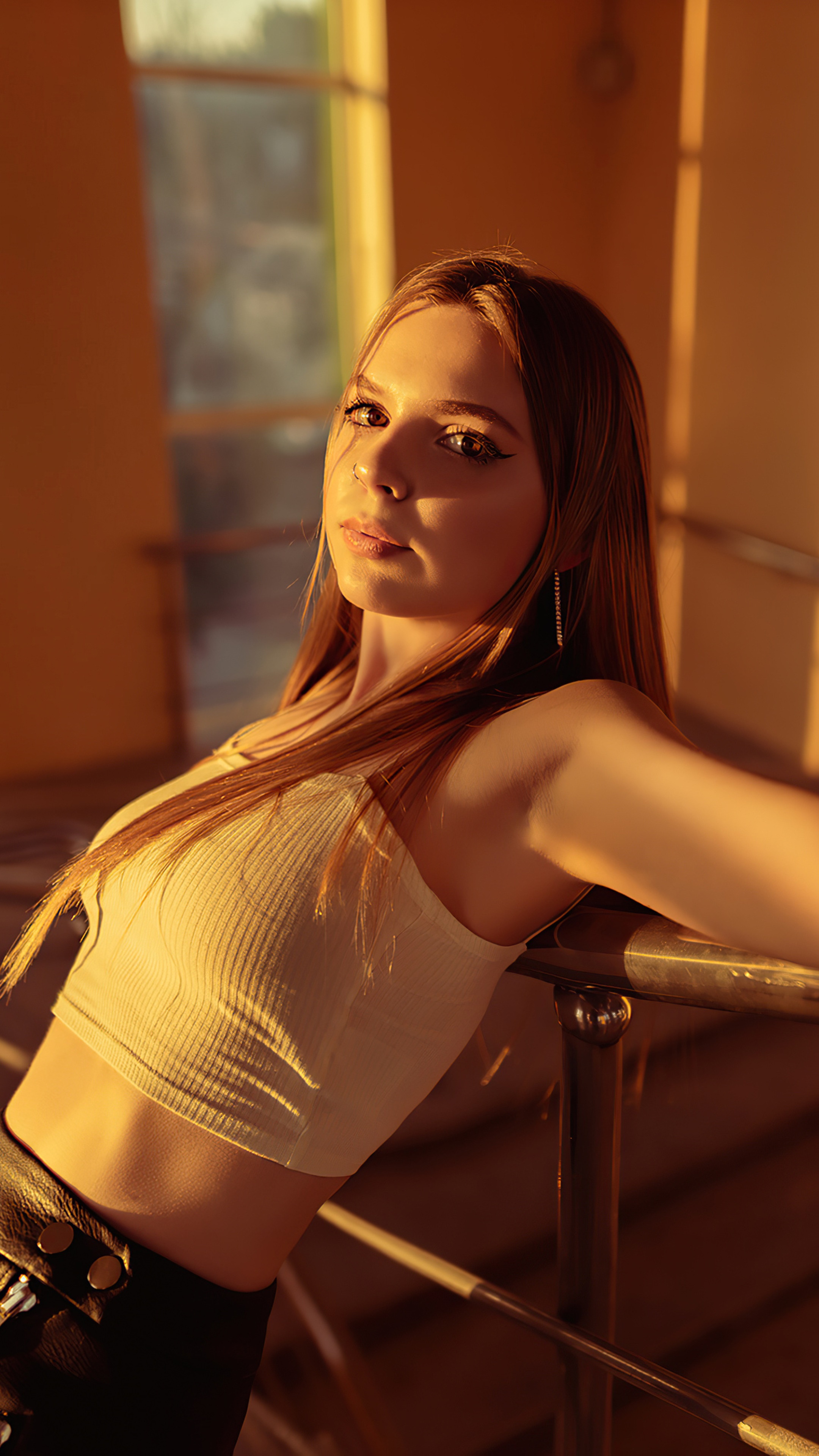 Model in white crop top leaning on railing HD Phone Wallpaper