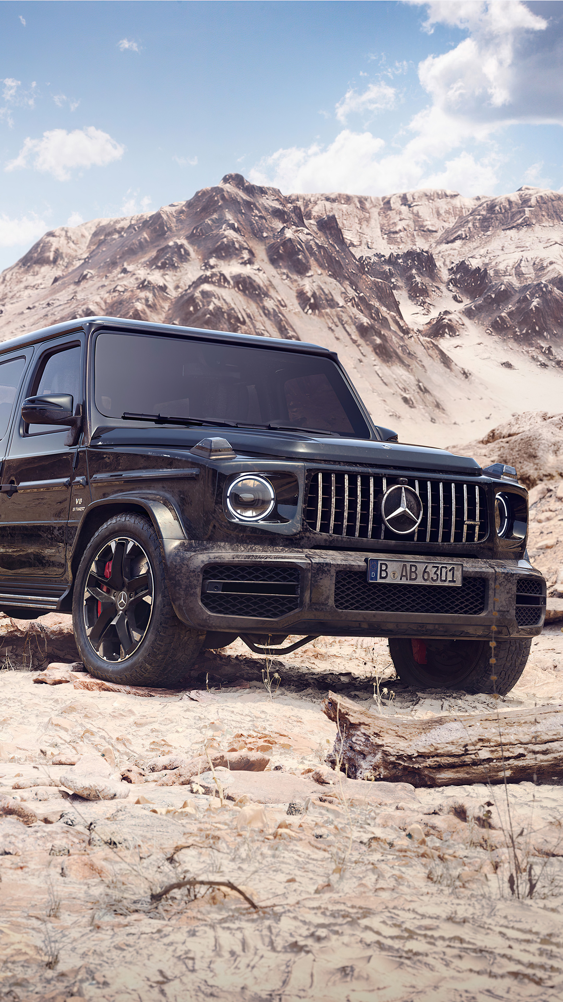 Black Mercedes-Benz G-Class SUV in a rocky desert landscape HD Phone Wallpaper