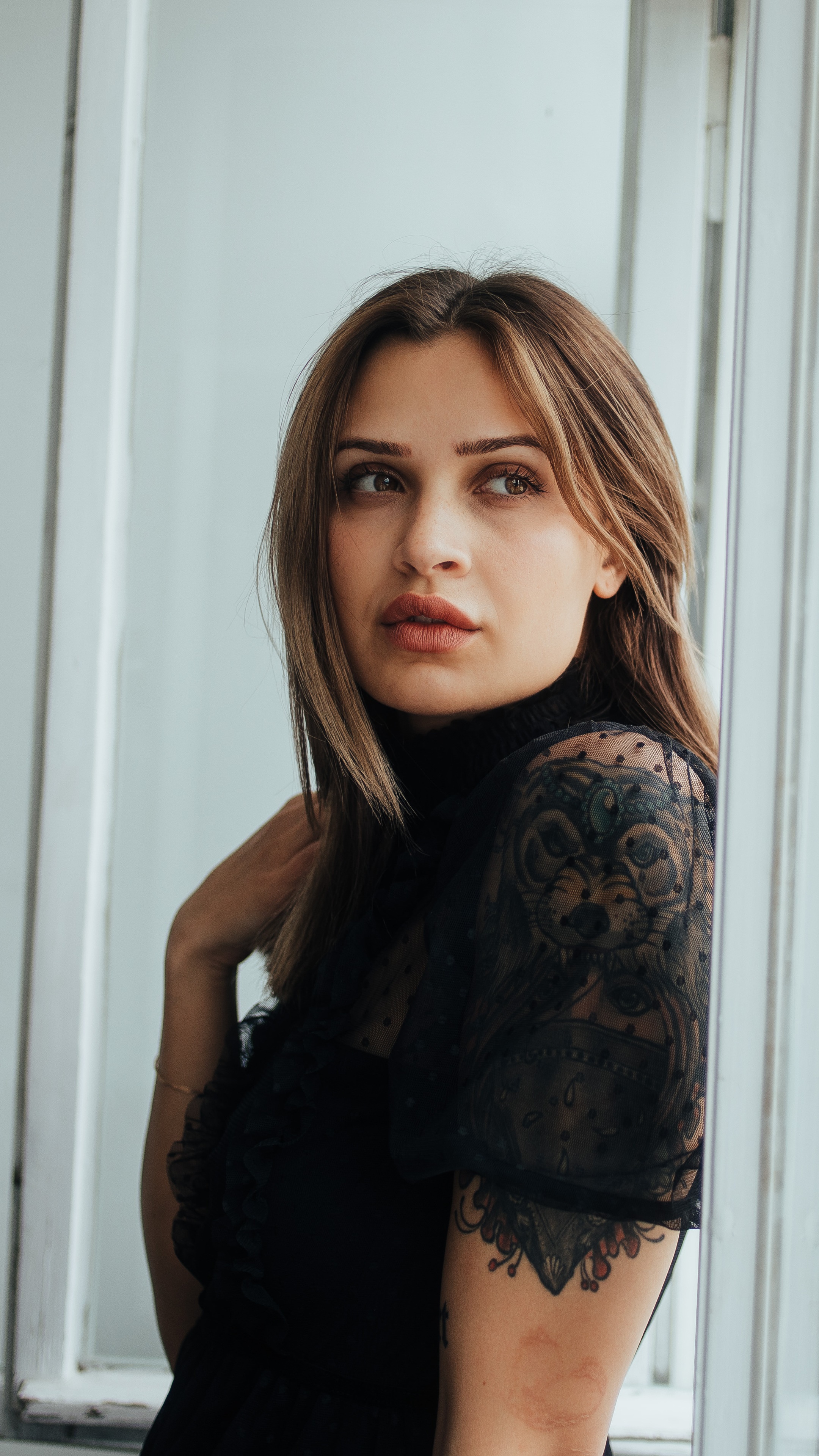 Woman with tattoo in black dress 4K HD Phone Wallpaper