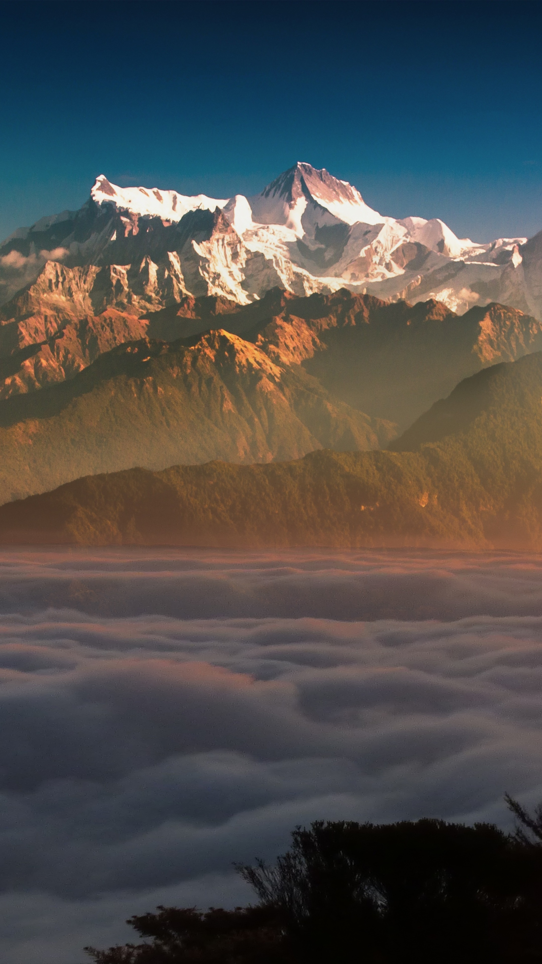 Snow-capped mountains above clouds at sunrise HD Phone Wallpaper