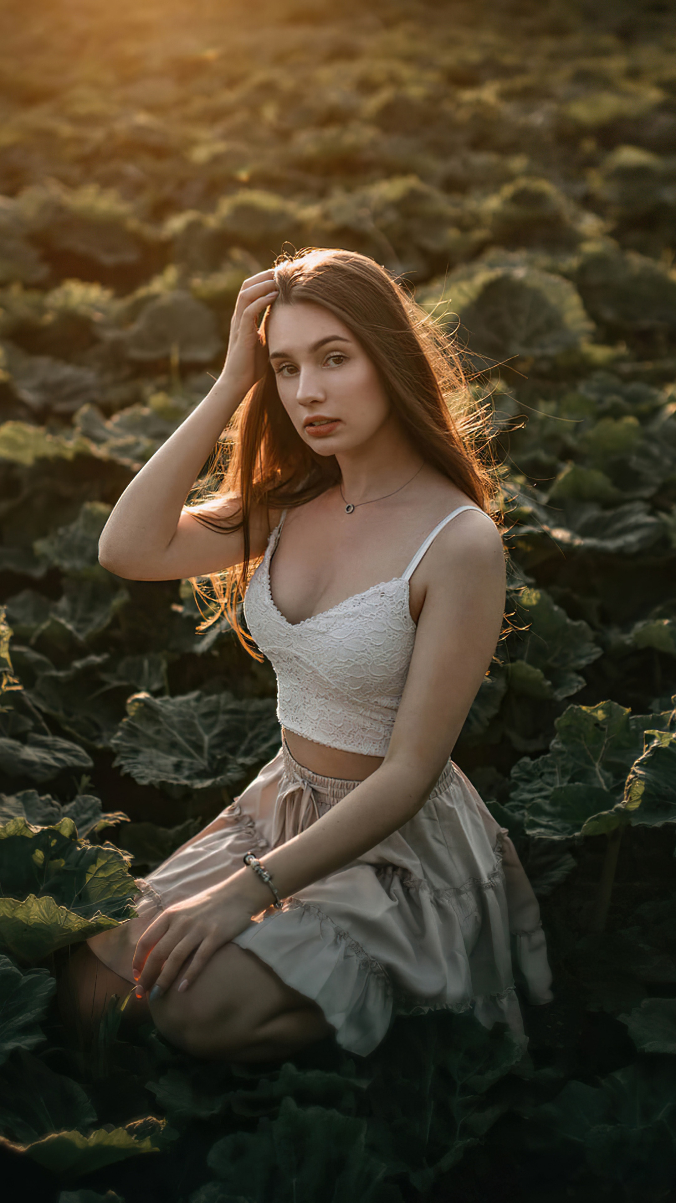 Model in a white top and skirt in a field HD Phone Wallpaper