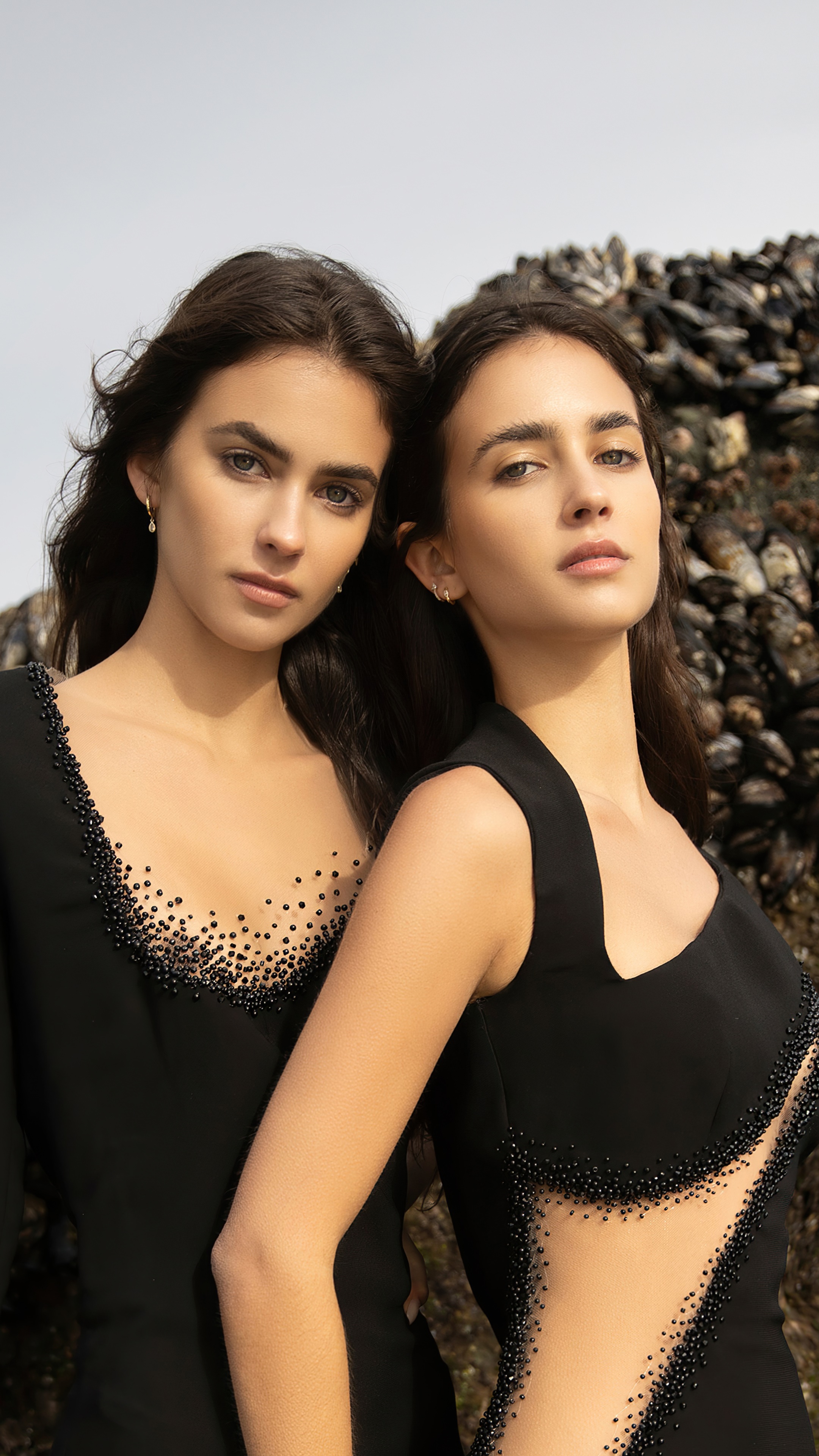 Two models in black dresses with beaded details HD Phone Wallpaper
